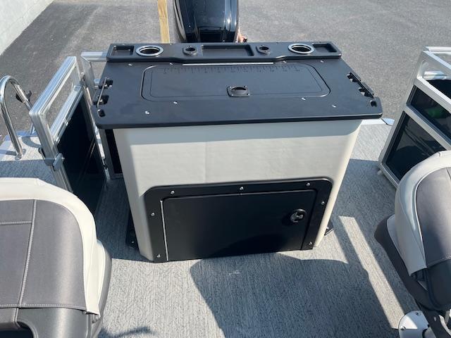 2026 Sun Tracker Fishin' Barge 20 DLX boat interior with seating and storage unit.
