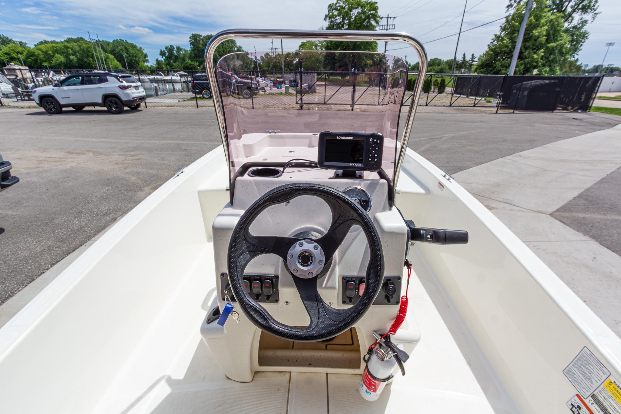 2020 Mako Pro Skiff 15 CC boat console with steering wheel and navigation system.