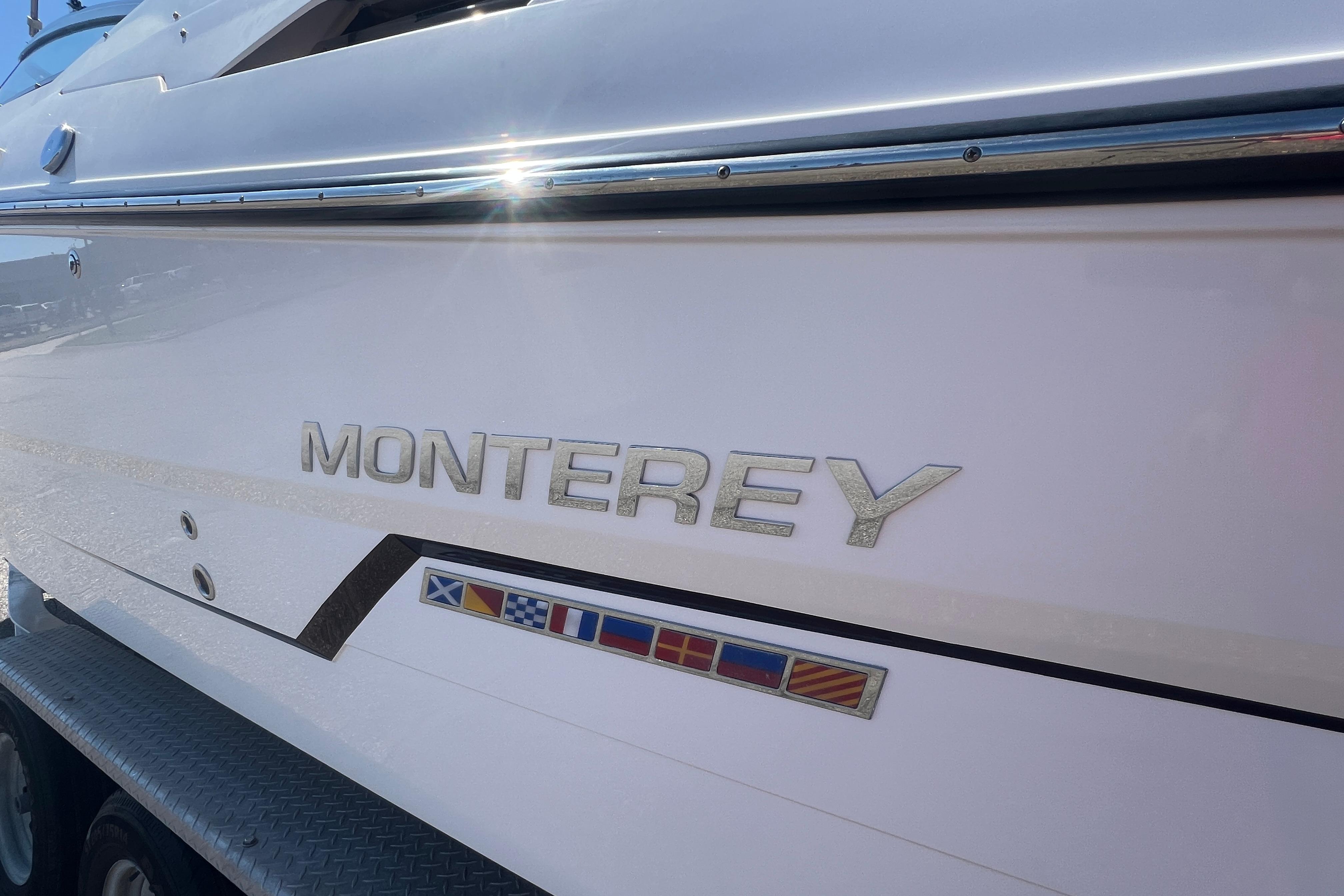 2017 Monterey 298SS Super Sport boat with nautical flags and sleek design.