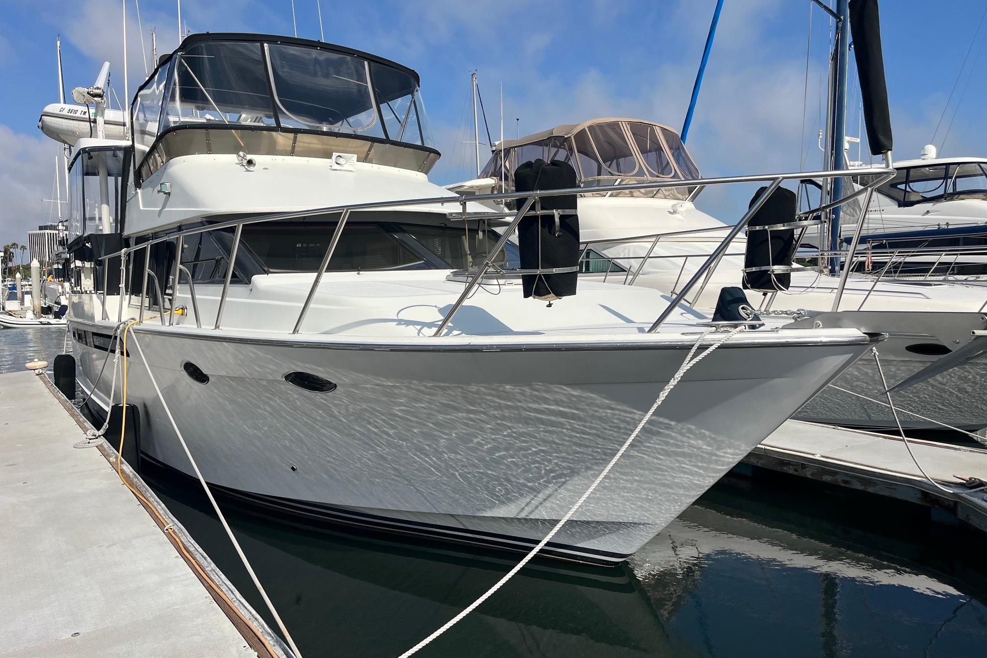 1989 Ocean Alexander 440 Sundeck CPMY yacht docked at marina, sunny day.