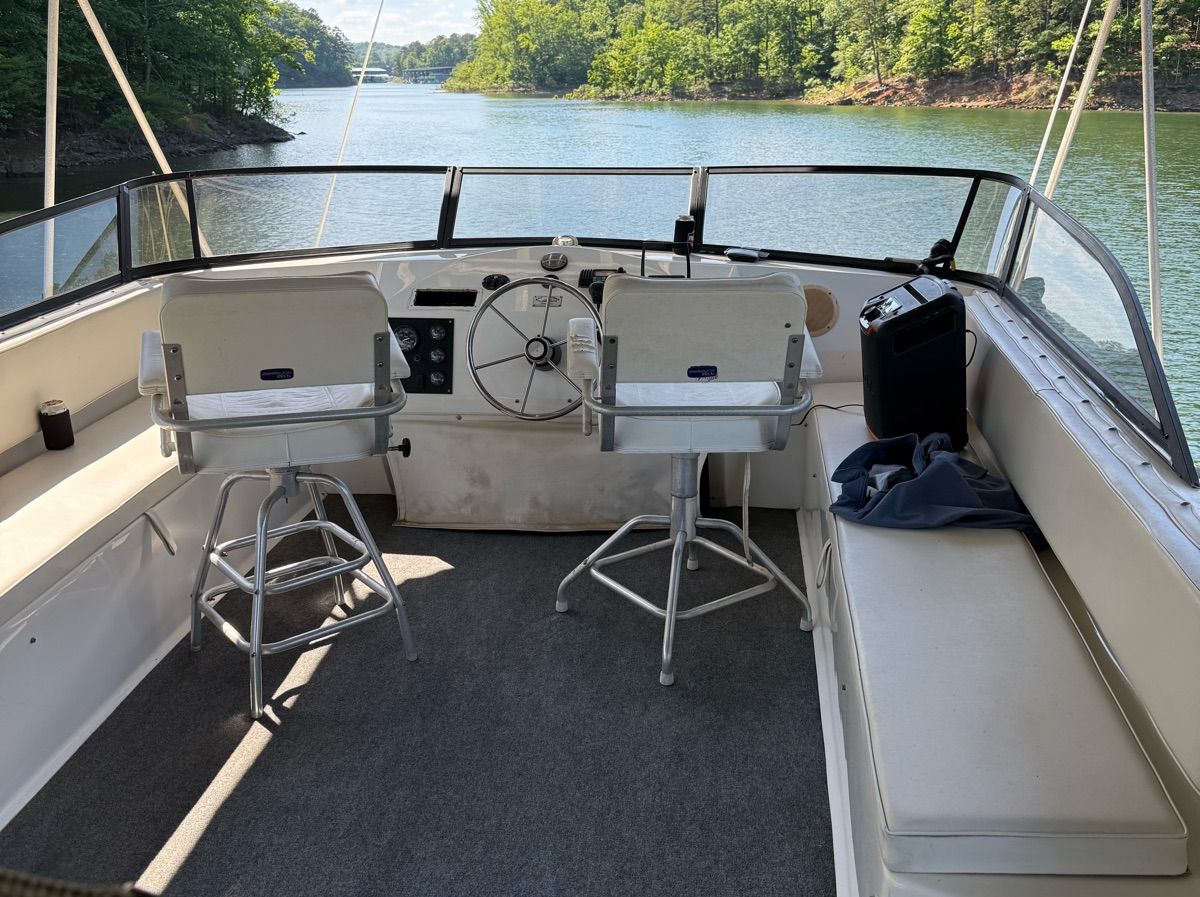 Interior of a 1998 Stardust Cruisers houseboat on a tranquil lake.