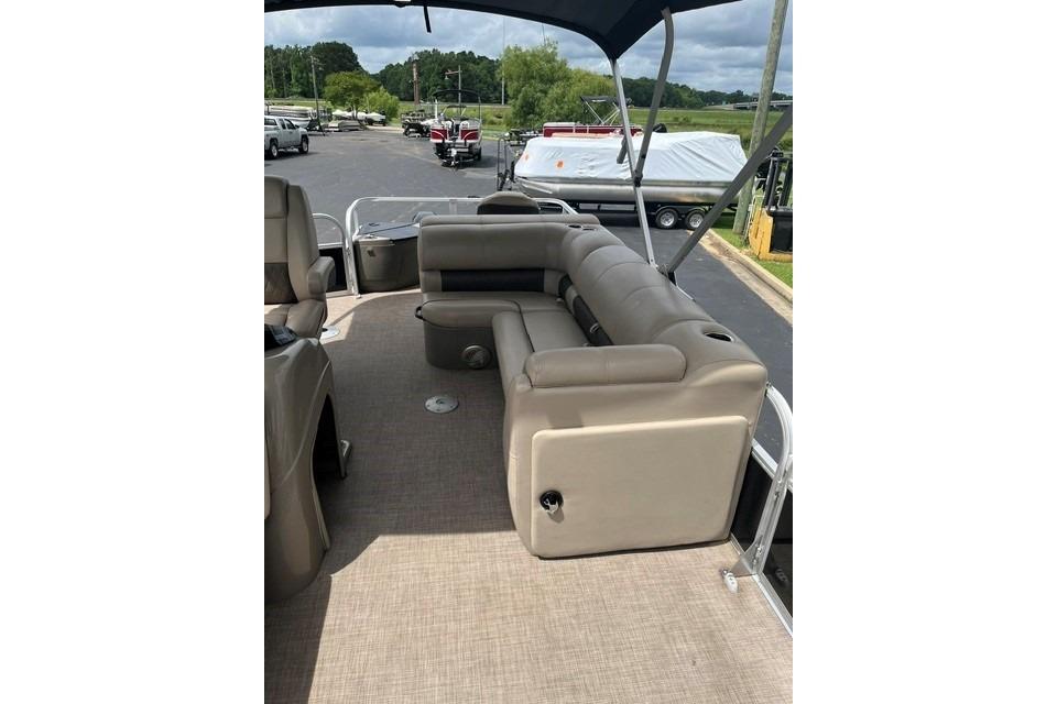 2023 SUNTRACKER Fishing Barge 20 interior with beige seating and canopy.