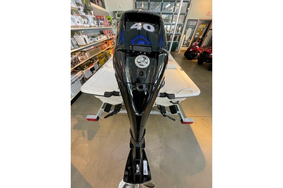 2026 Mako Pro Skiff 13 CC outboard motor displayed in a showroom.