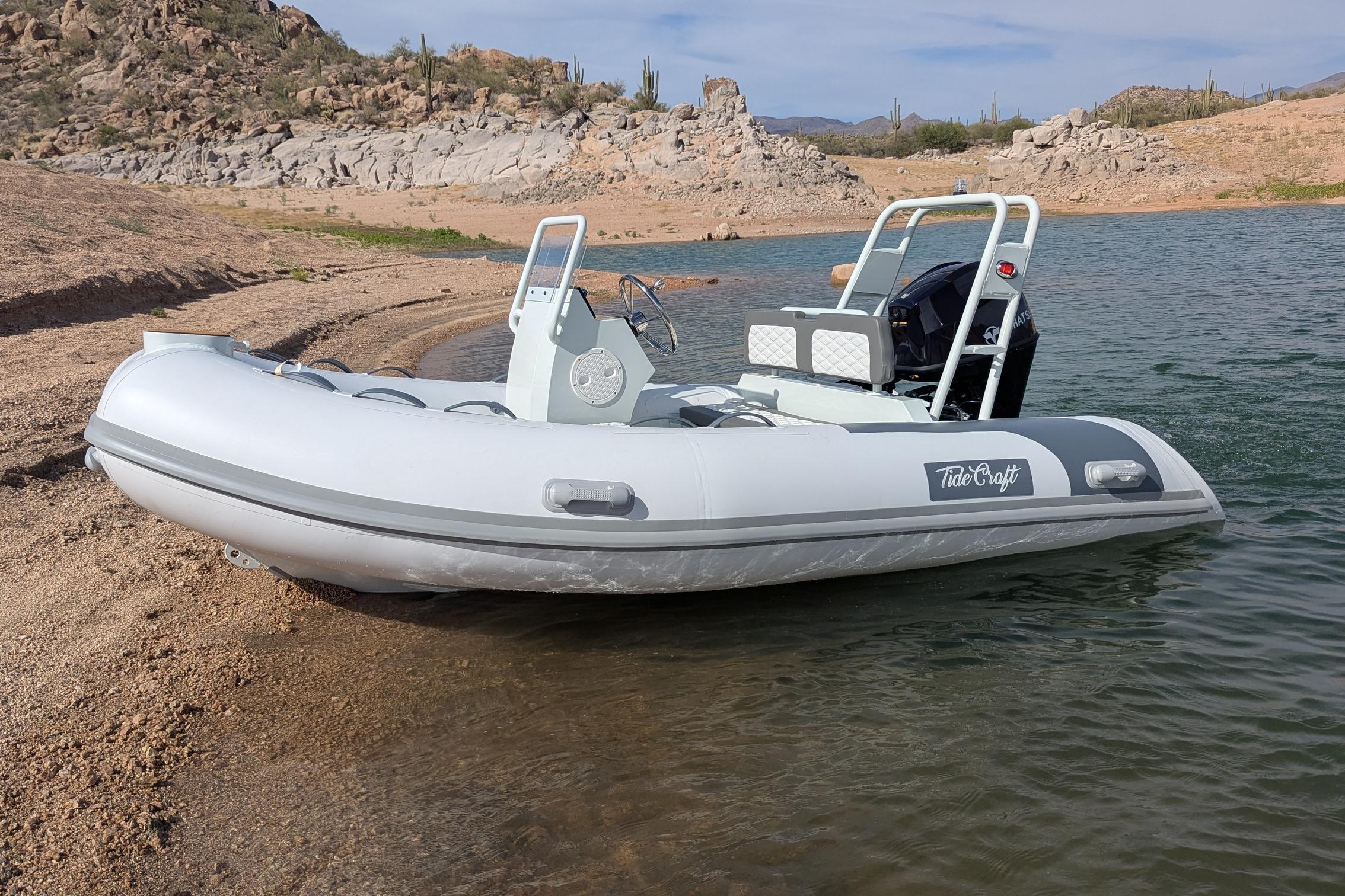 2027 Tide Craft San Juan 11 inflatable boat on a rocky shoreline.