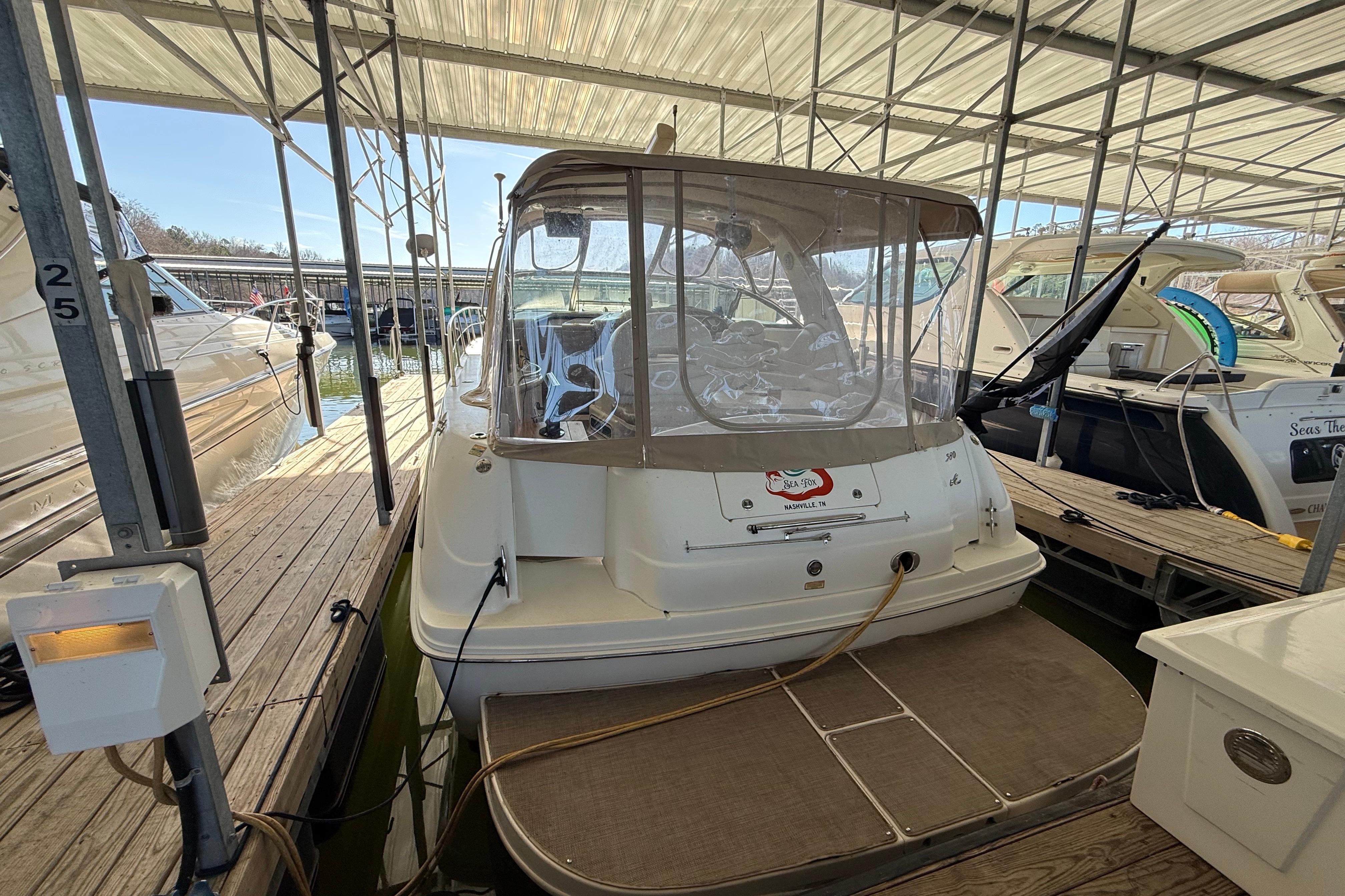 2001 Sea Ray 380 Sundancer docked in a covered marina slip.