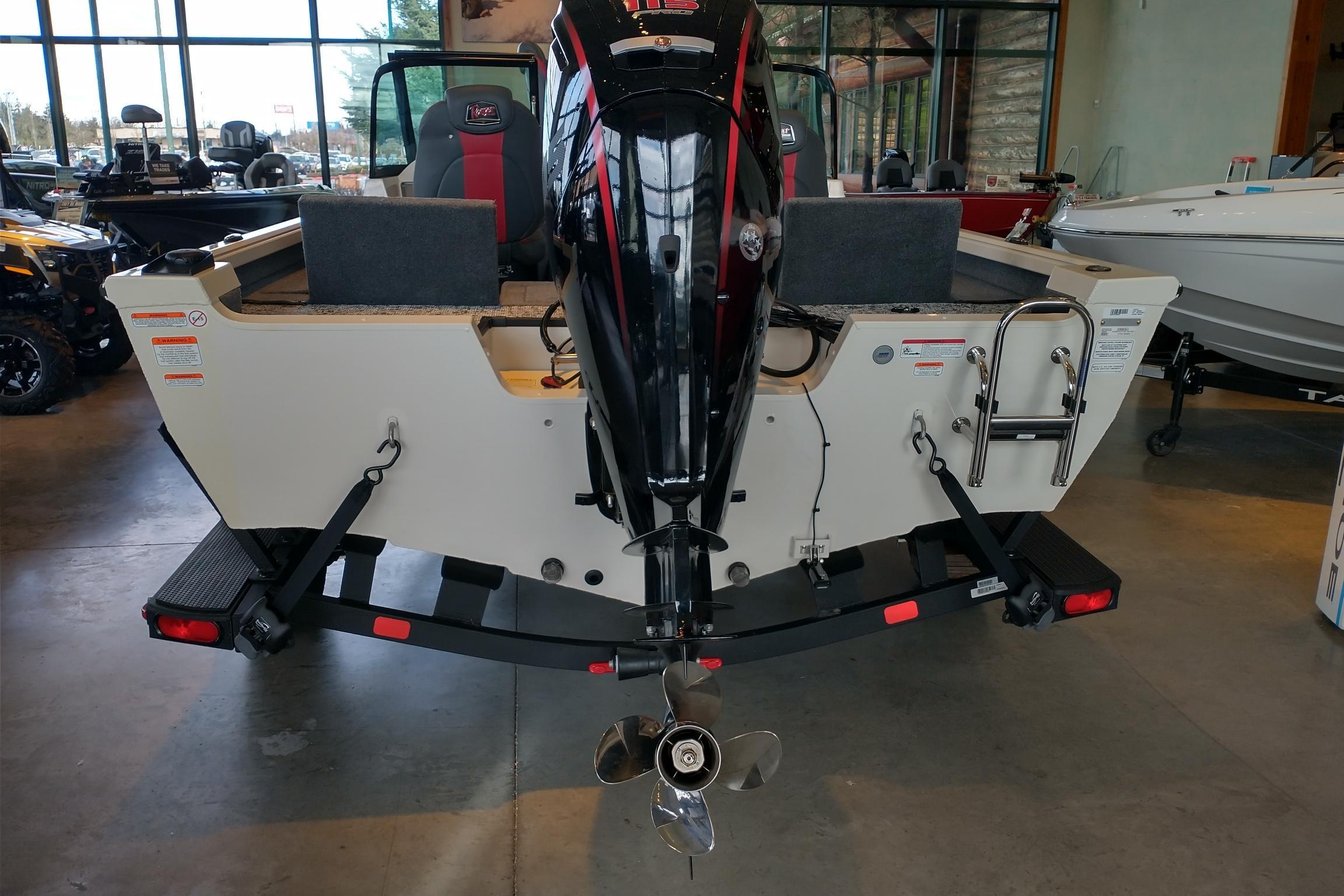 2026 Ranger VS1682SC Reata boat rear view with motor and ladder in showroom.