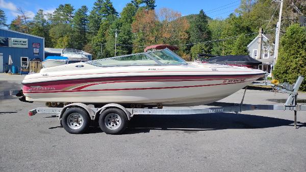 1999 Chaparral 2130 SS boat on trailer, parked outdoors.