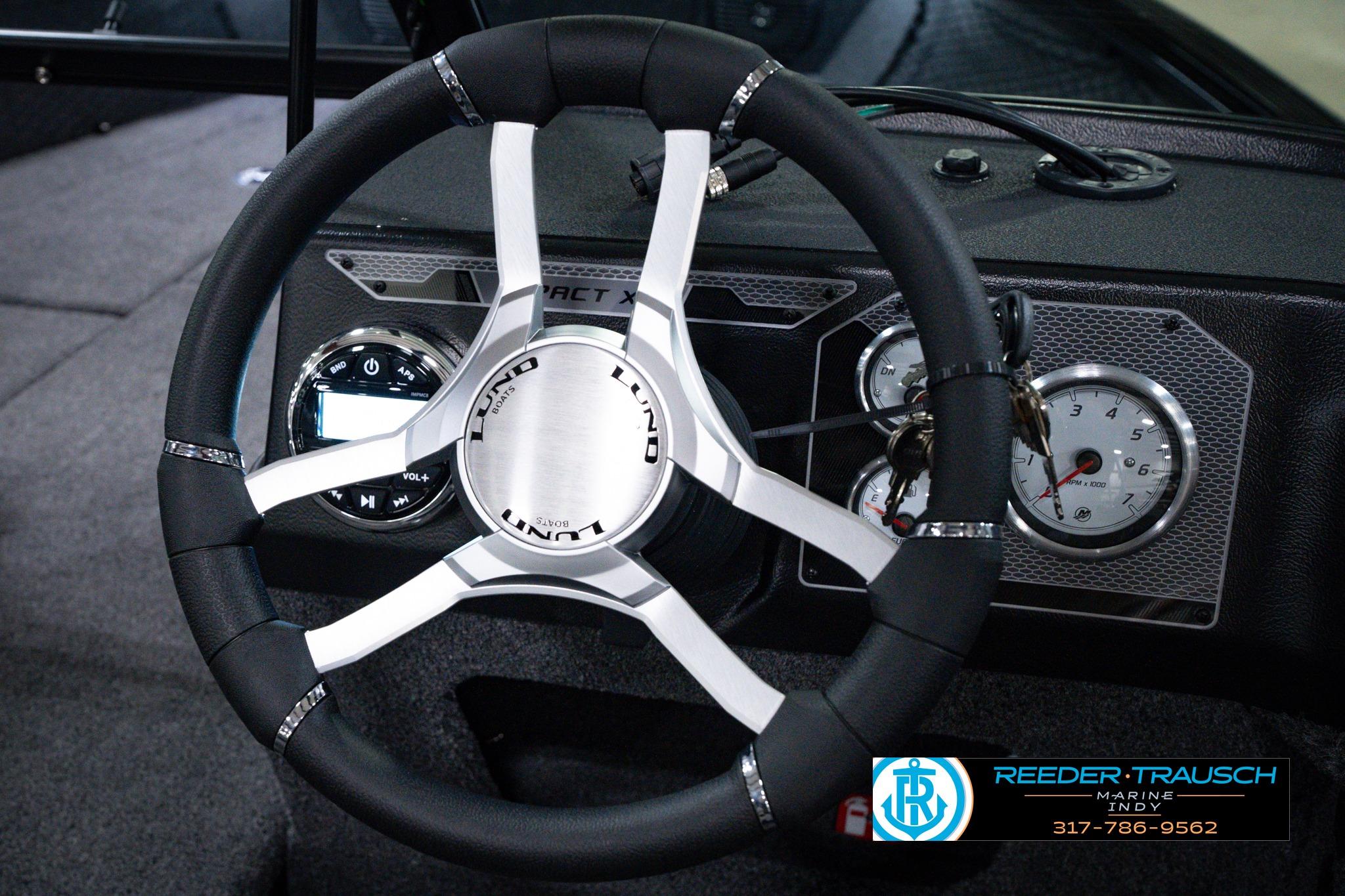 Steering wheel of 2026 Lund 1875 Impact XS SS boat with dashboard instruments.