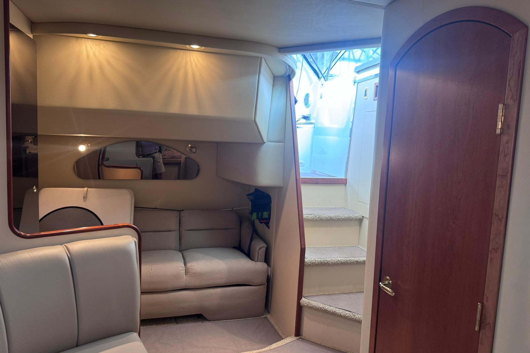 Interior of 2002 Cruisers Yachts 3275 Express, featuring cozy seating and elegant design.
