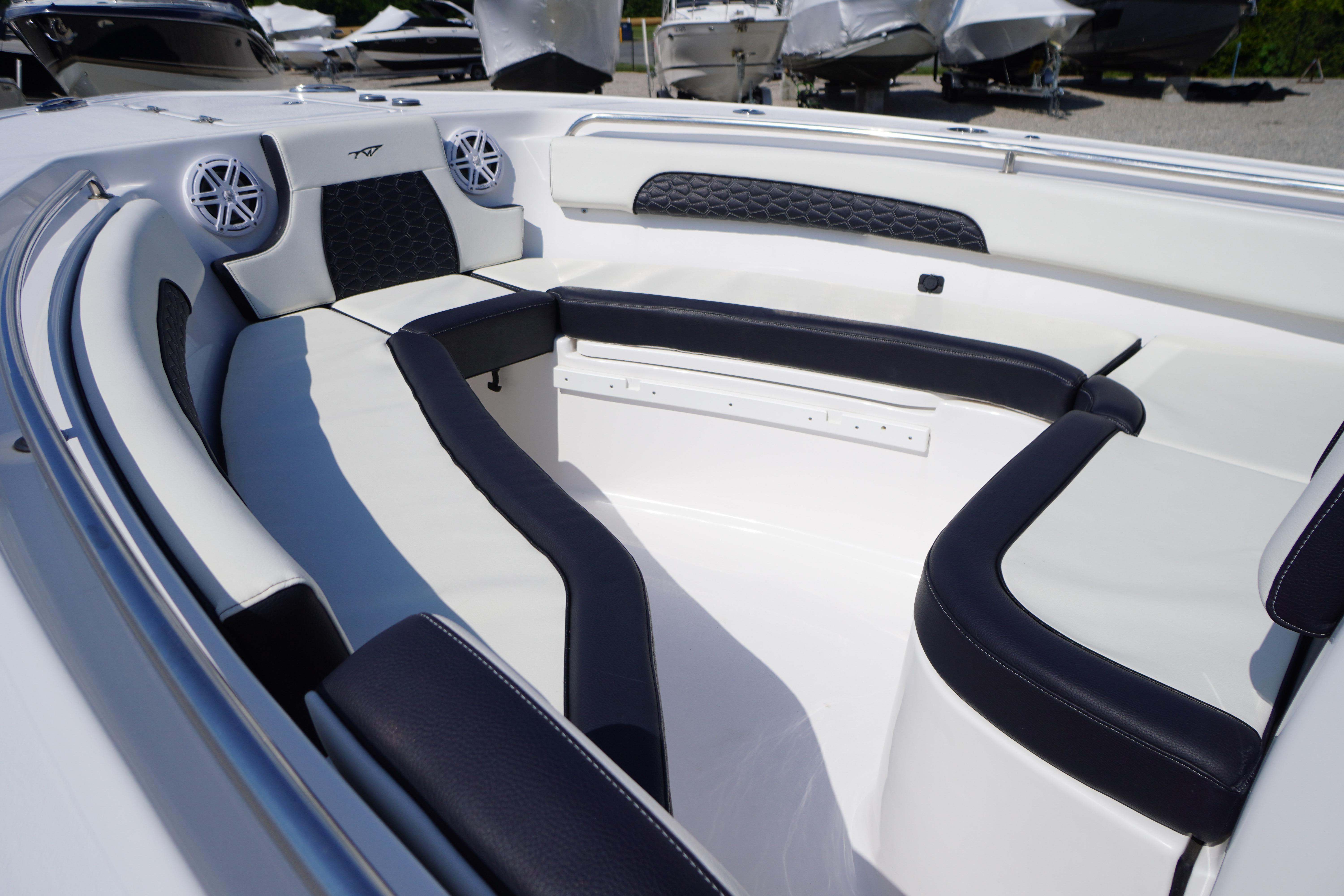 2025 Tidewater 232 SS boat interior with cushioned seating and speakers.