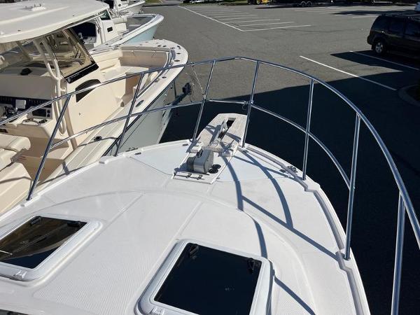 2025 Cutwater C-248 C Coupe boat deck with railing and hatches in a marina.