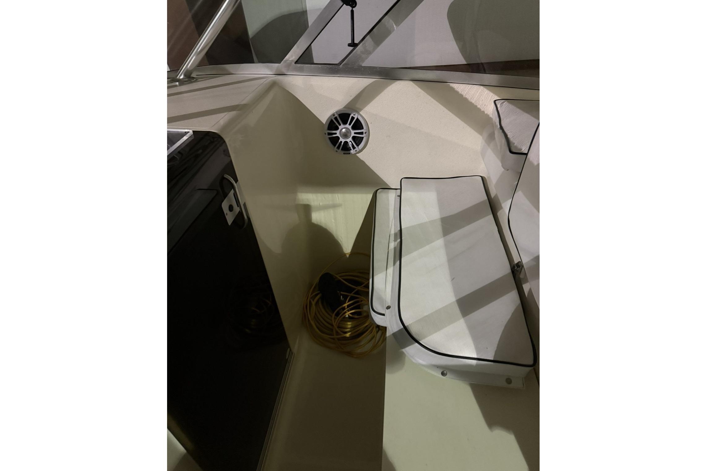 Interior of 2000 Pursuit 3070 Offshore Center Console boat with seating and speaker.