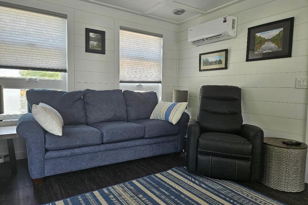 Interior of 2021 East Coast Houseboats Freedom 40, featuring cozy seating and modern decor.