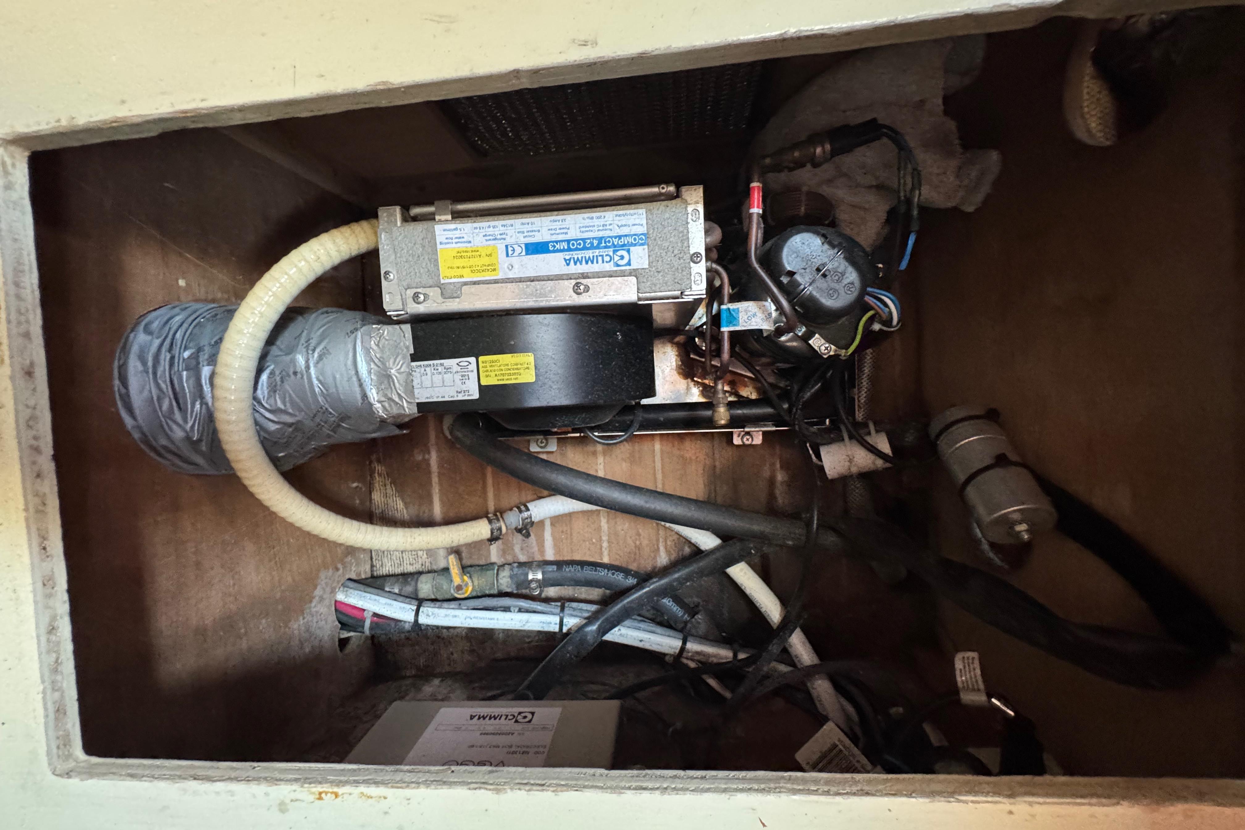 Electrical components inside a 1989 Cape Dory 30 Motorsailer, featuring wiring and ventilation.