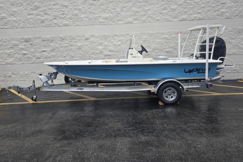 2026 Mako 18 Pro Skiff boat on trailer, parked outdoors.
