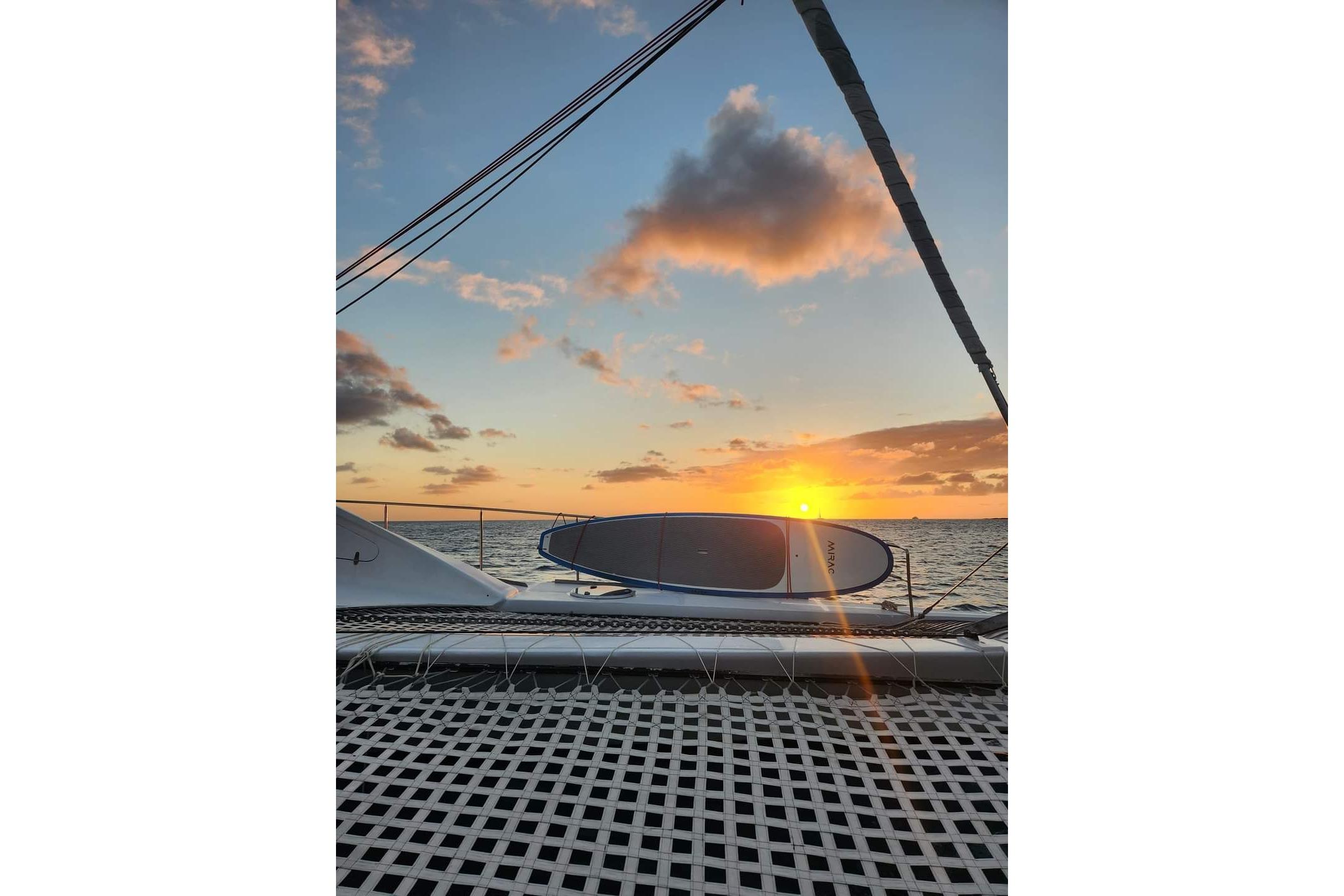 Sunset view from Erasmus Yachts 52, 2019 model, with surfboards on deck.