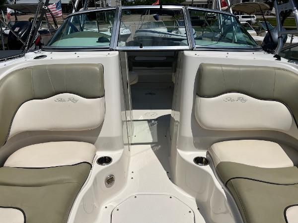 2005 Sea Ray 220 Sundeck interior with beige seating and open deck layout.