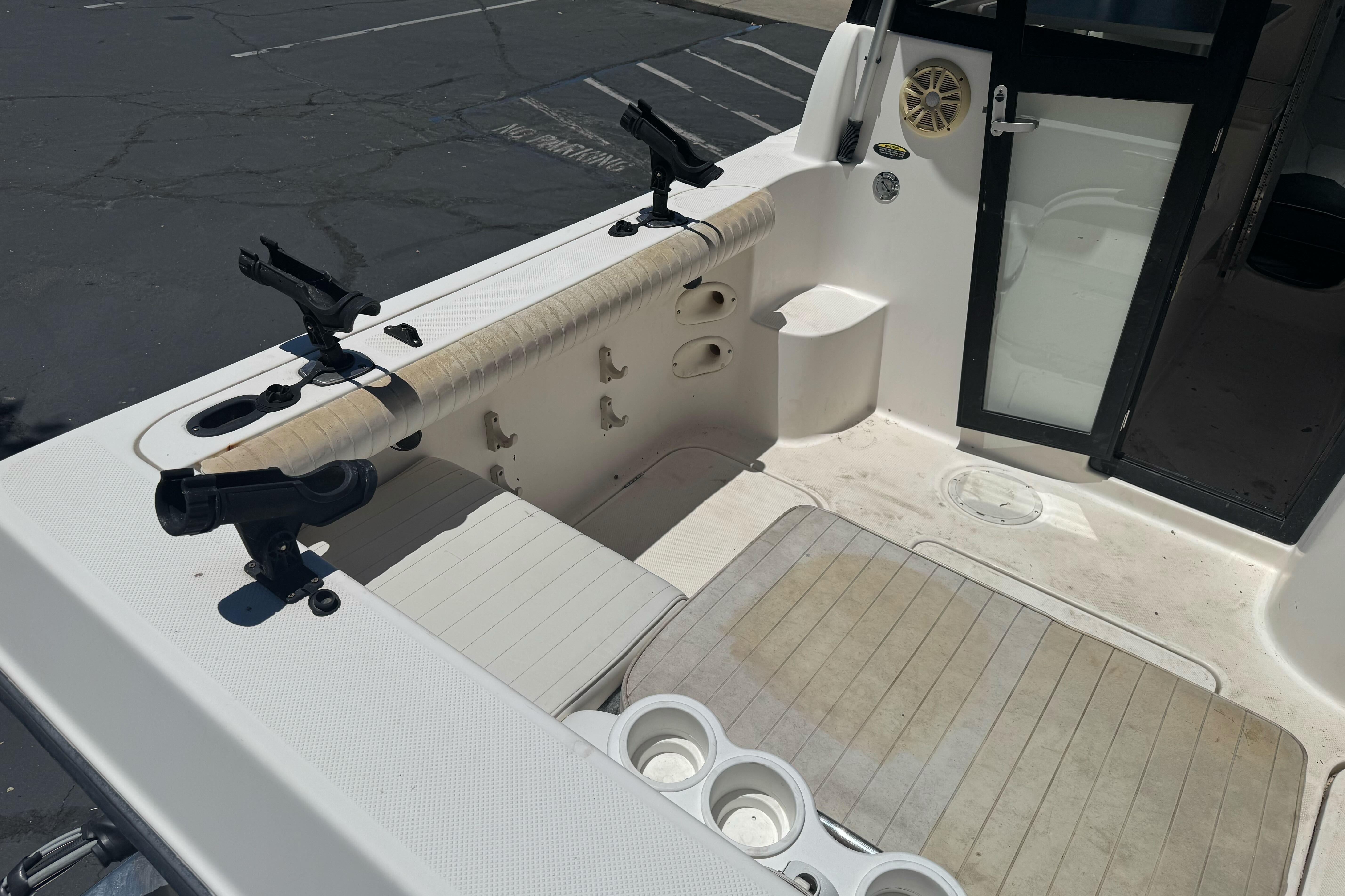 2004 Trophy 2359 WA boat interior with rod holders and seating area.