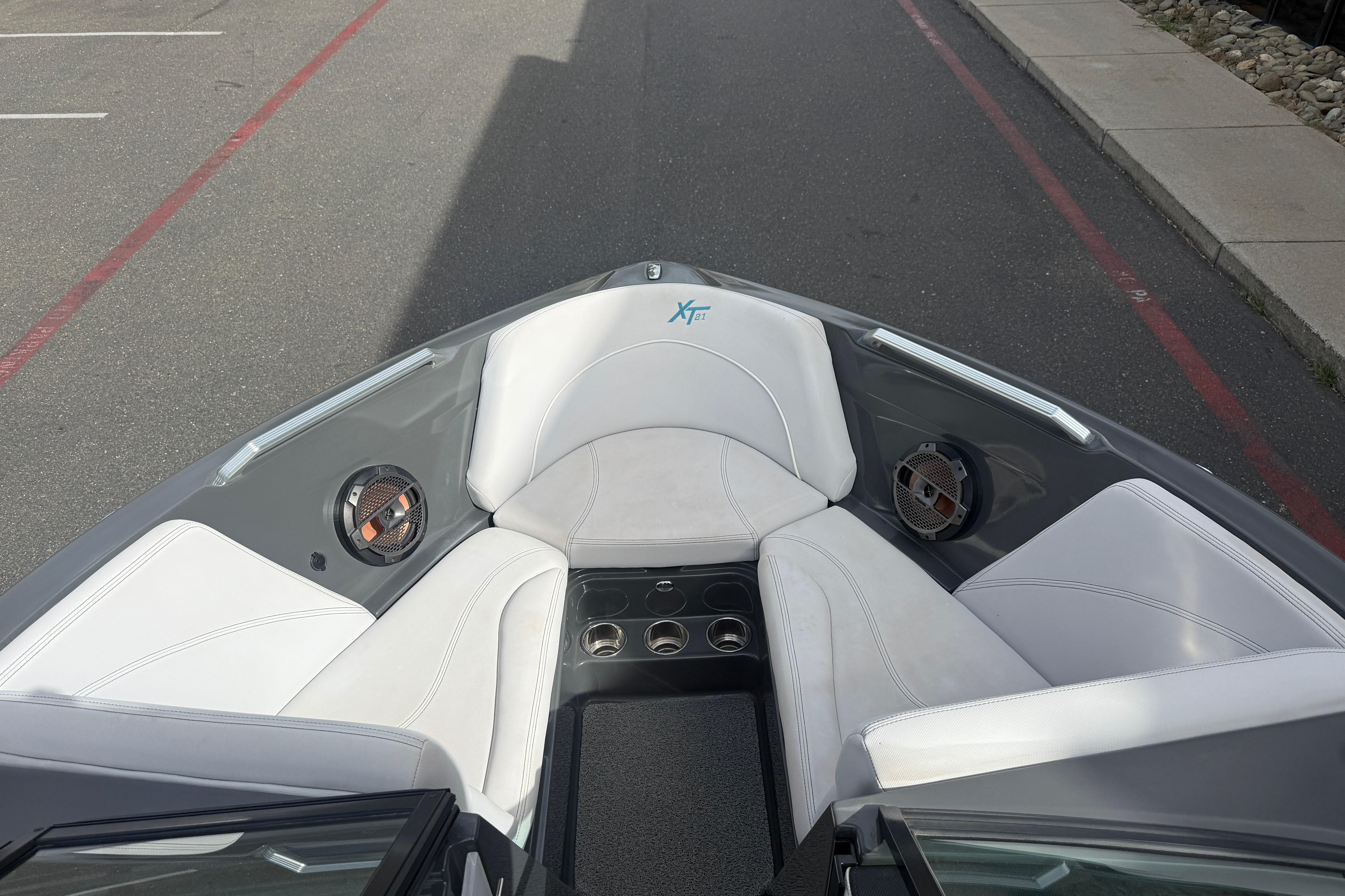 2018 MasterCraft XT21 boat interior with white seating and built-in speakers.