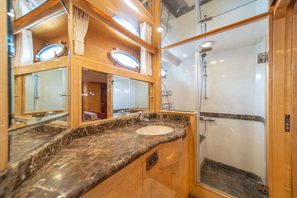 Luxurious bathroom in 2005 Ocean Alexander 64 Motoryacht with marble countertop and shower.