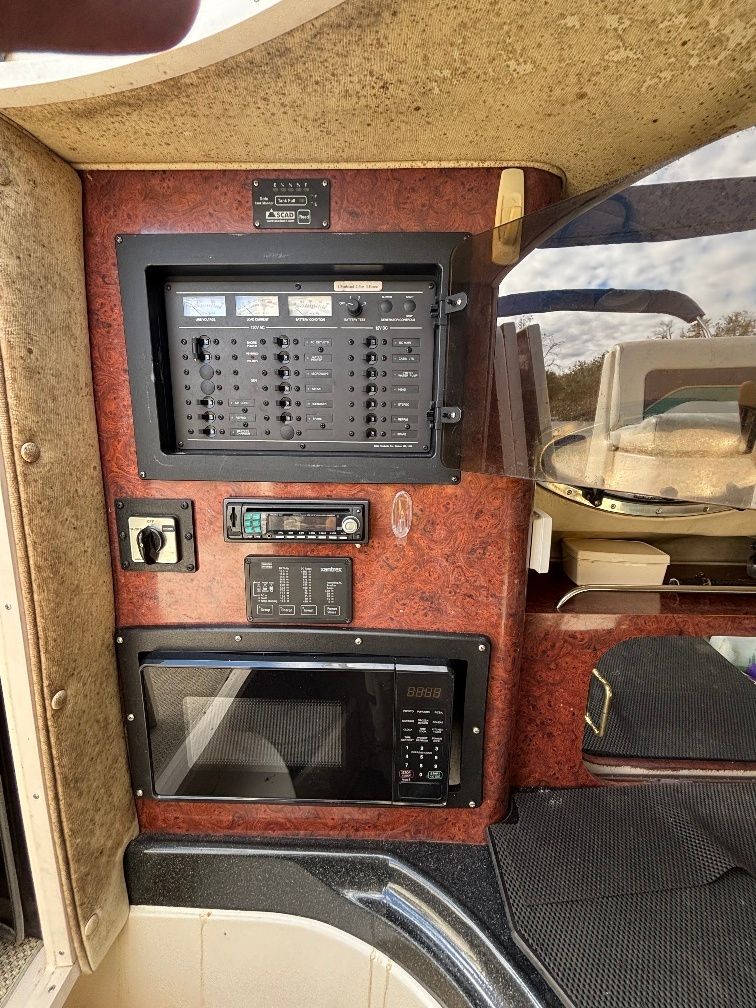 Interior of a 1997 Donzi 275LXC with control panel and microwave.