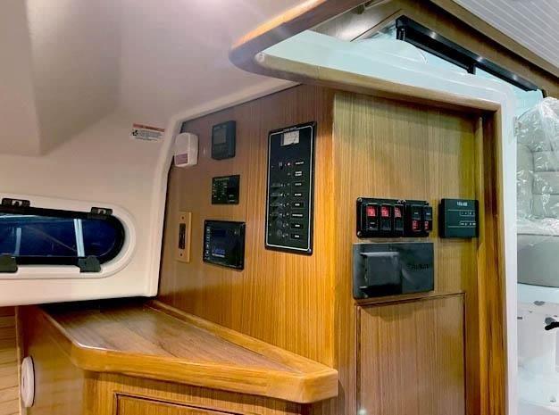 2024 True North 34 yacht interior with control panels and wood finish.