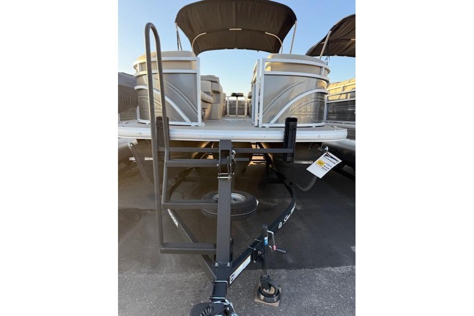 2025 Sun Tracker Party Barge 22 XP3 pontoon boat with trailer ladder, parked outdoors.