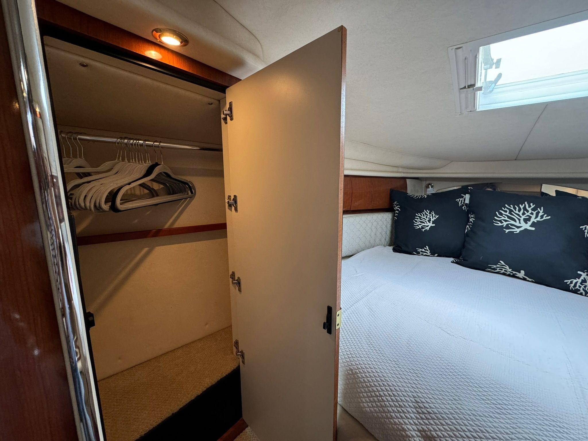 Interior of 2002 Sea Ray 360 Sundancer with bed and closet.