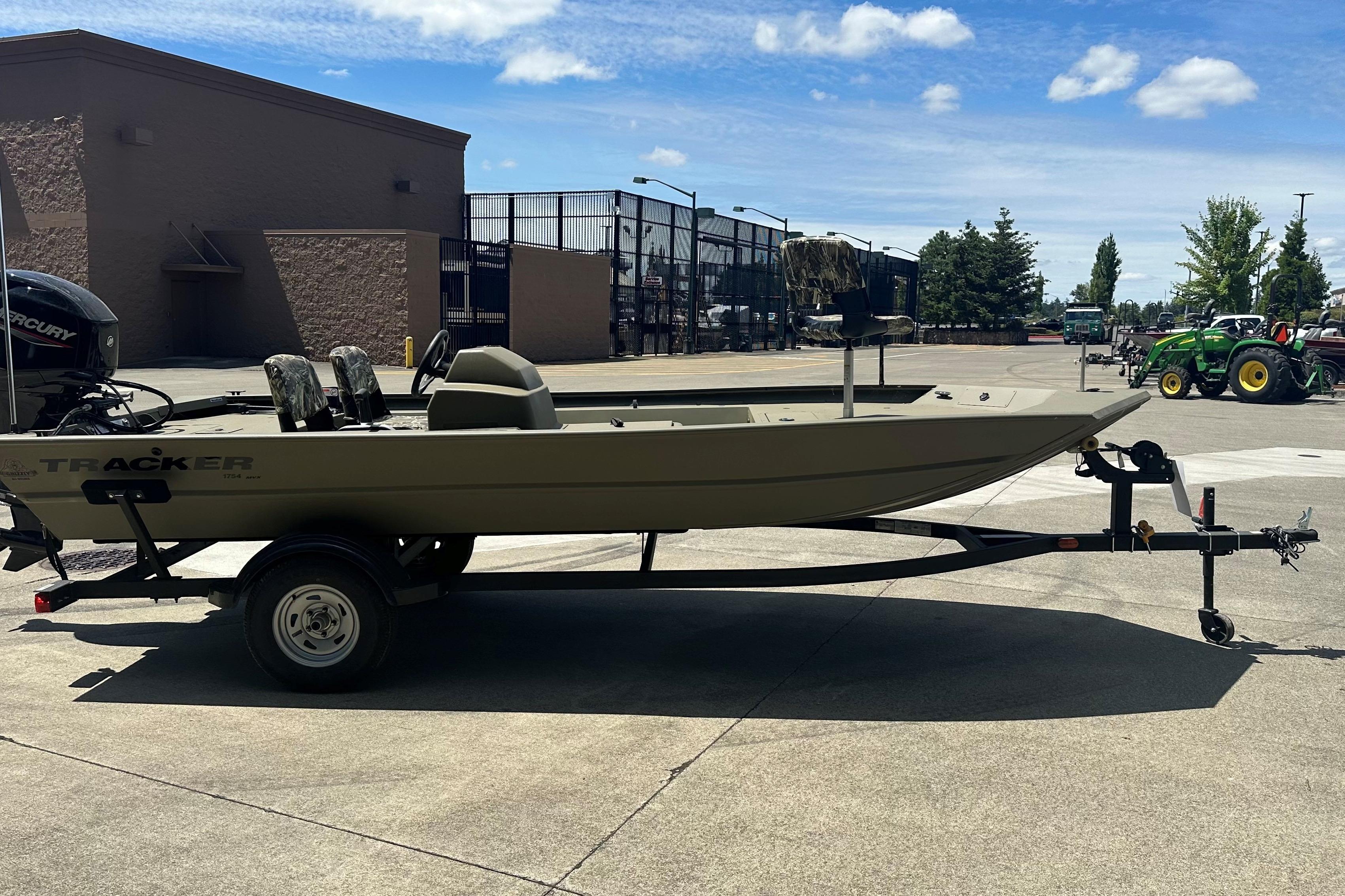 2026 Tracker Grizzly 1754 SC boat on trailer in outdoor setting.