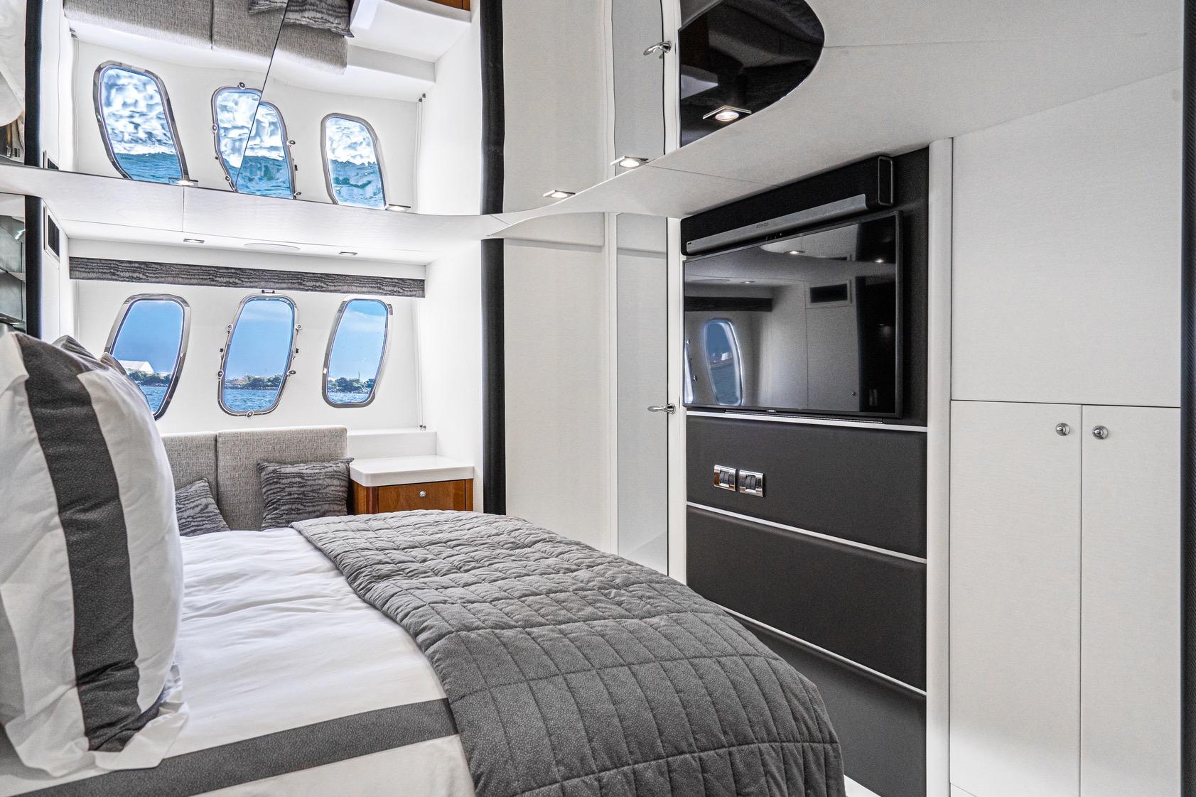 Luxurious interior of 2021 Sunseeker Predator 68 yacht with modern bedroom design.