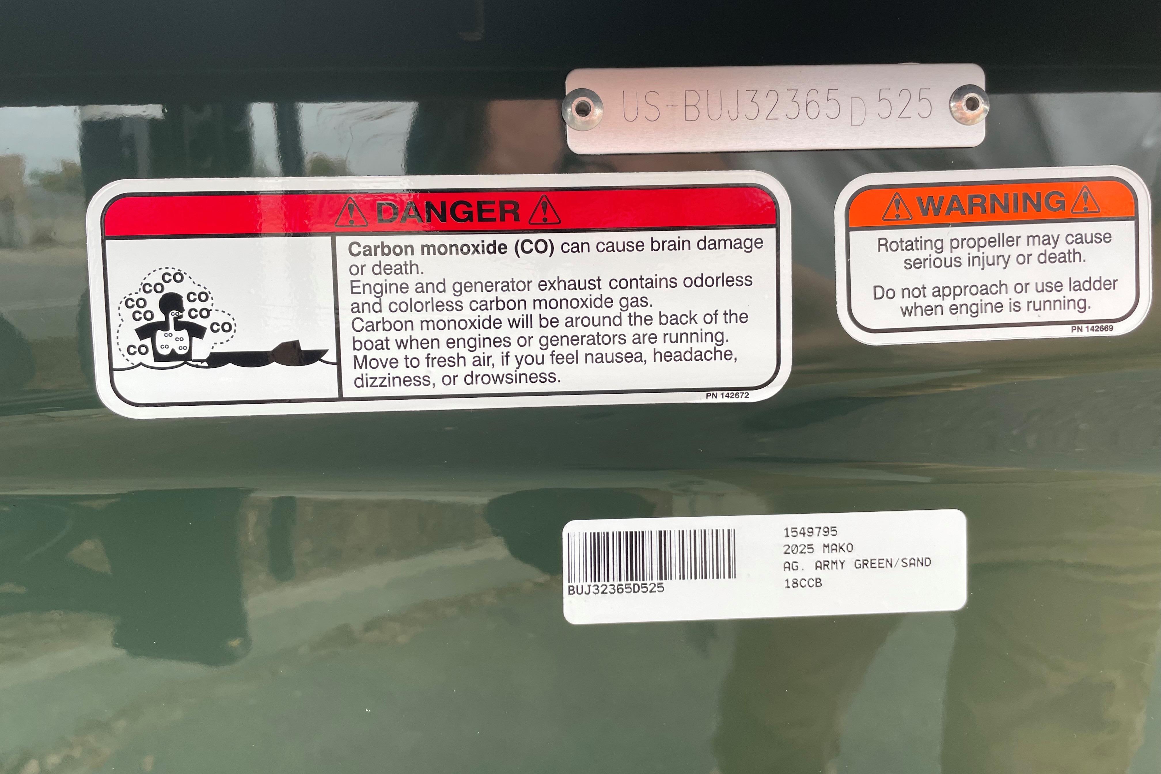 Warning labels on 2025 Mako 18 Pro Skiff Backwater Edition boat, highlighting safety hazards.