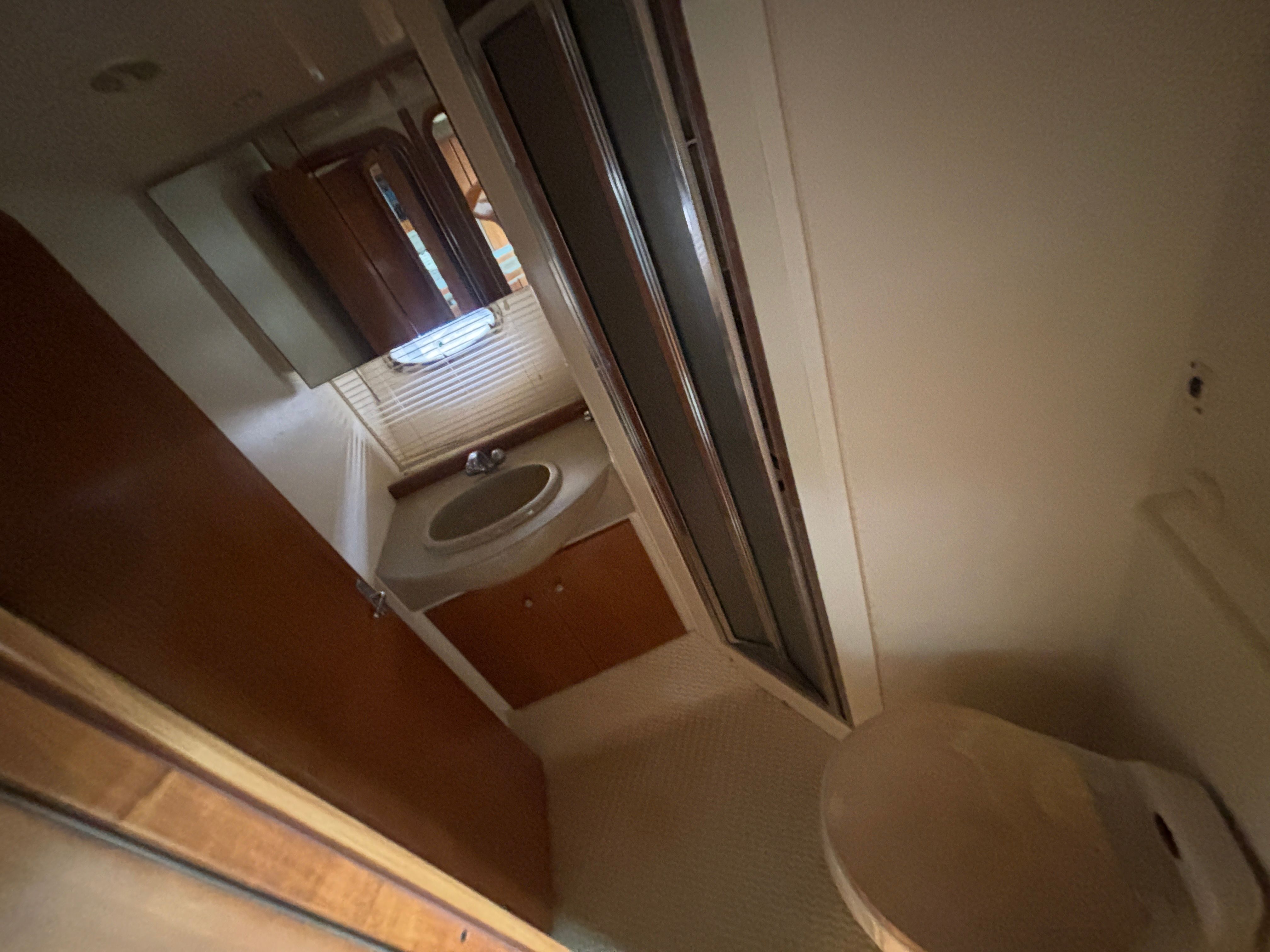 Interior of a 2001 Carver 350 Mariner with a sink, mirror, and shower.