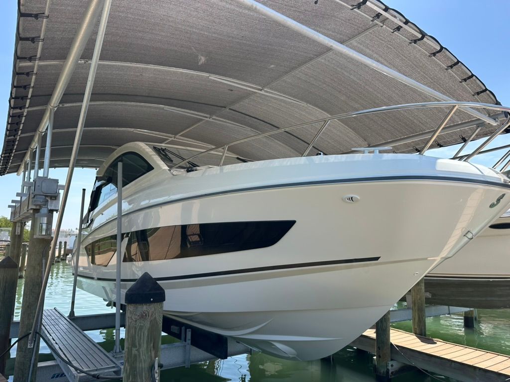 2024 Beneteau Gran Turismo 32 on a boat lift under a canopy.