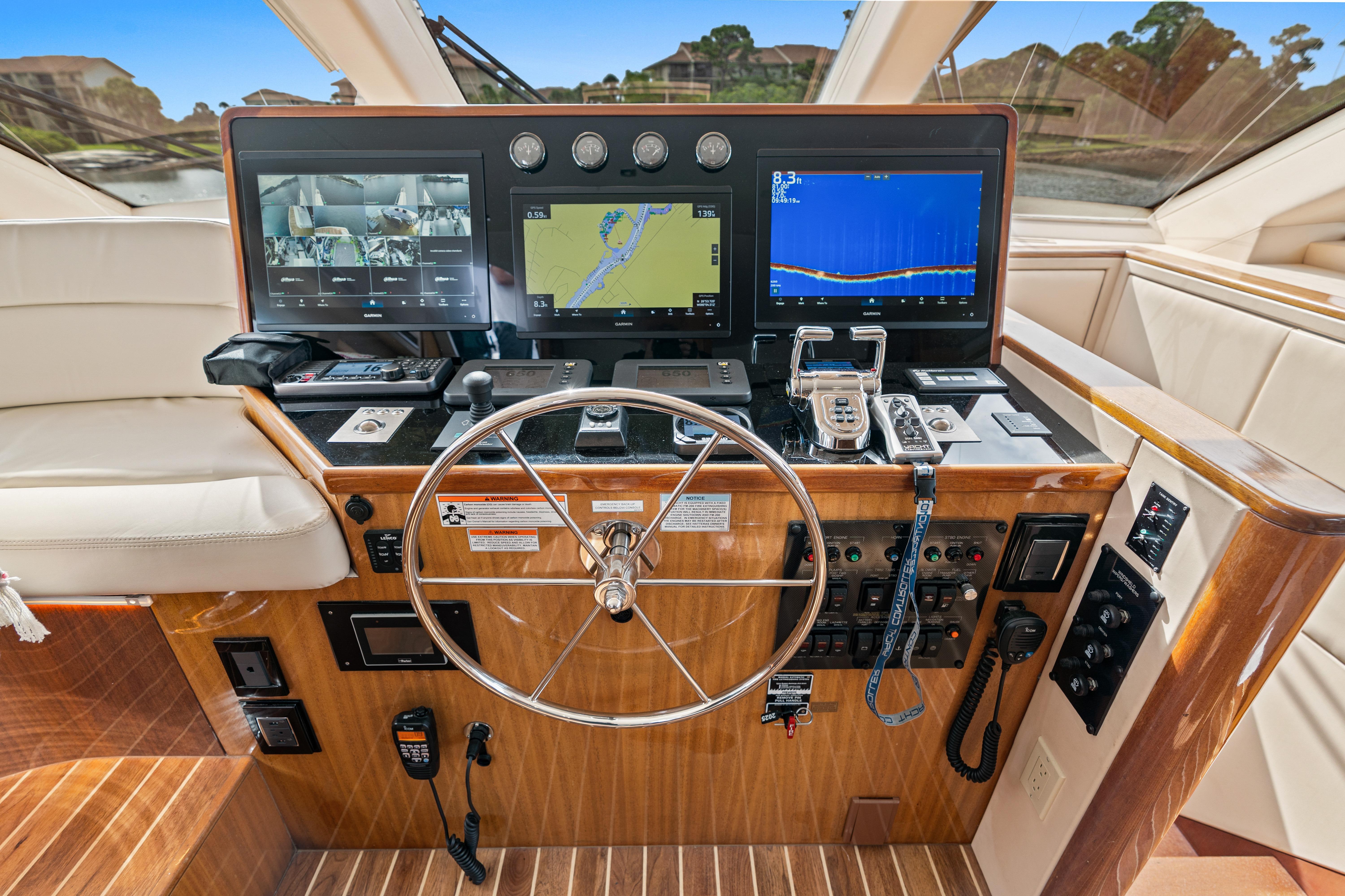 Helm of 2008 Hatteras 64 Motor Yacht with navigation screens and controls.
