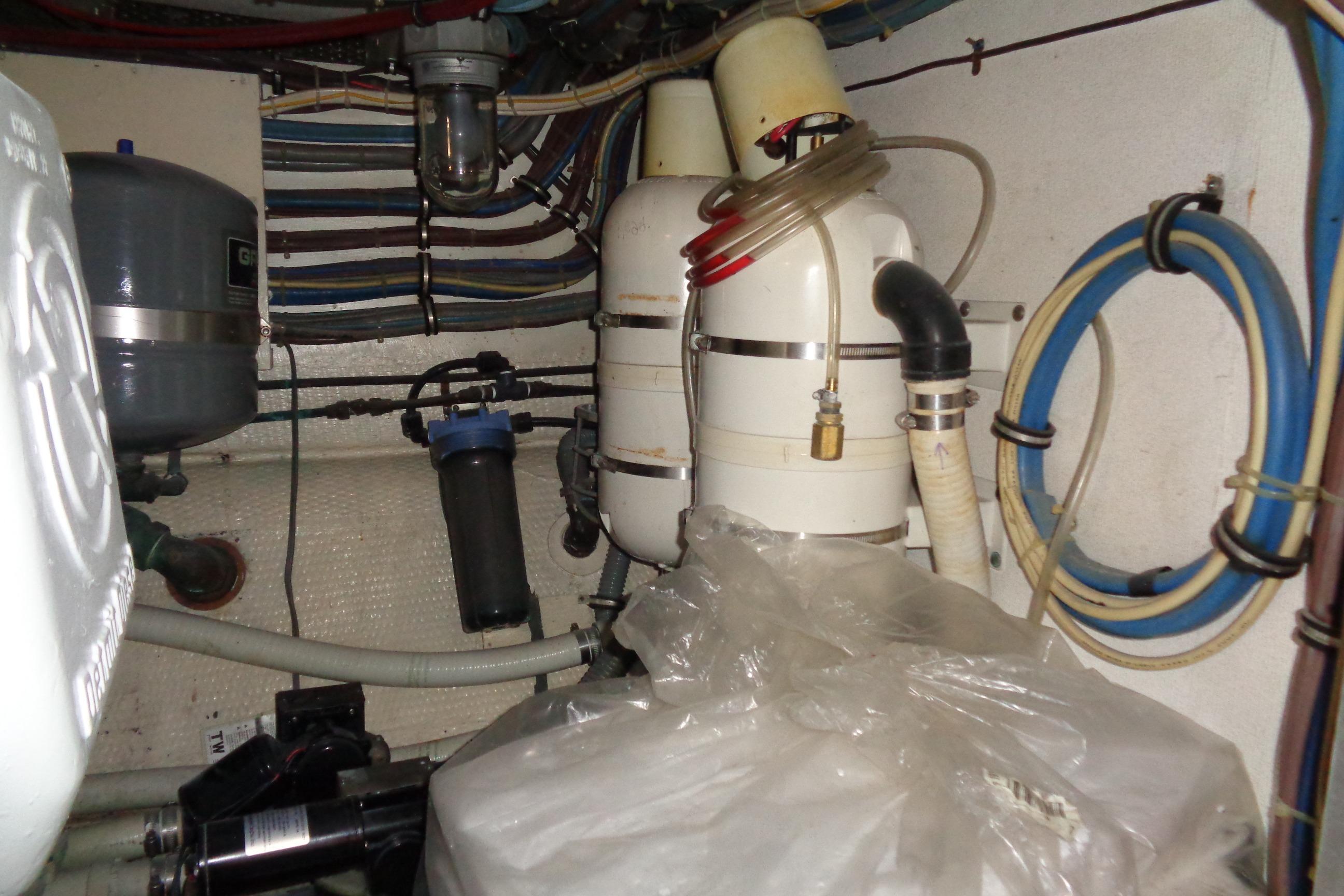 Engine room of 1981 Hatteras 48 Cockpit Motor Yacht with various mechanical components.