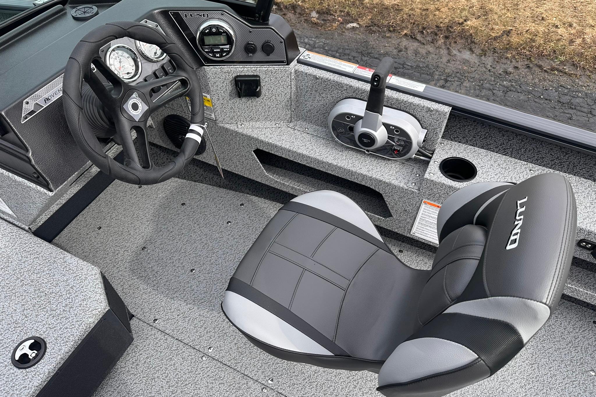 2026 Lund 1775 Adventure Sport boat interior with steering wheel and control panel.
