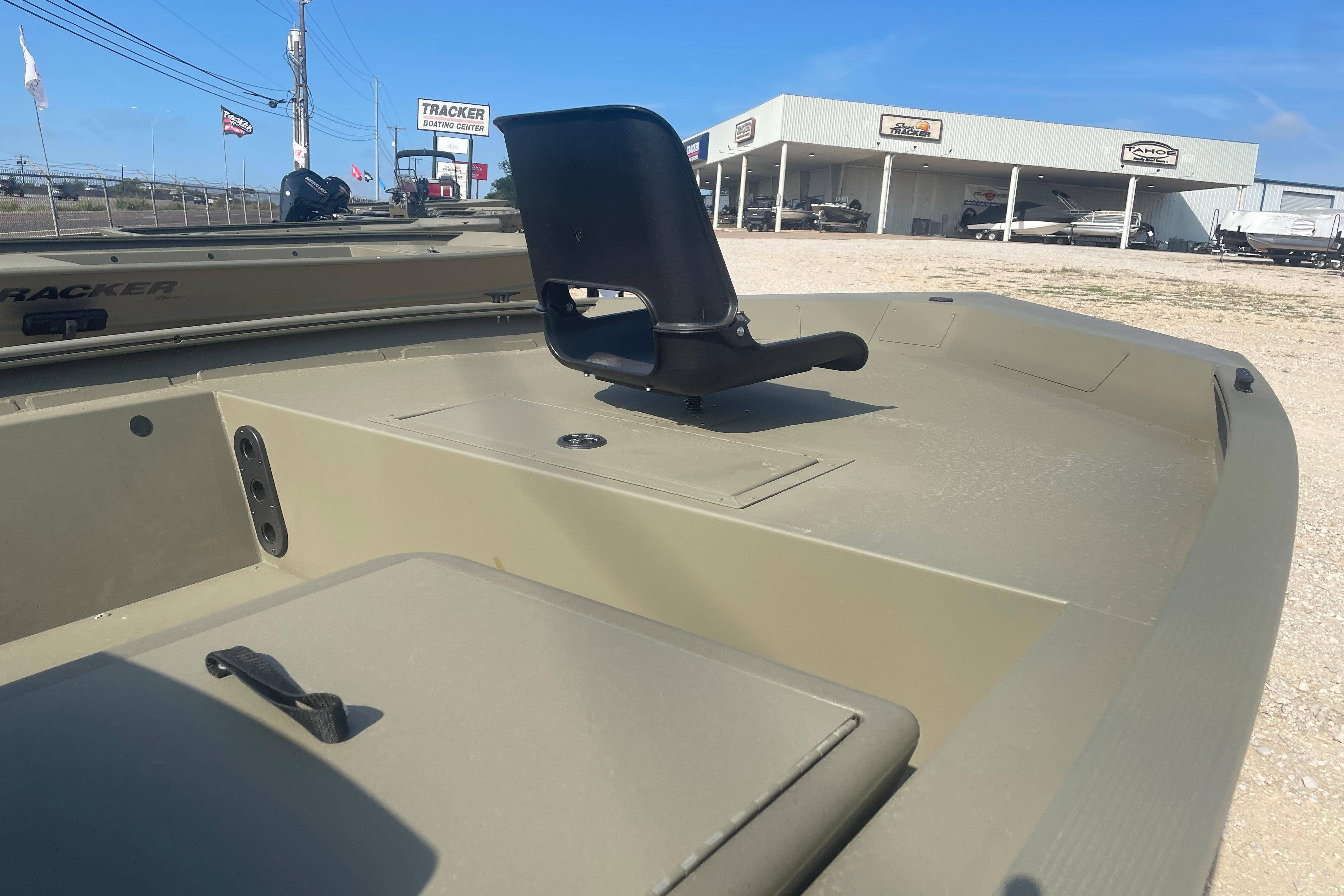 2026 Tracker Grizzly 1754 SC boat at dealership, featuring a sleek design and comfortable seating.