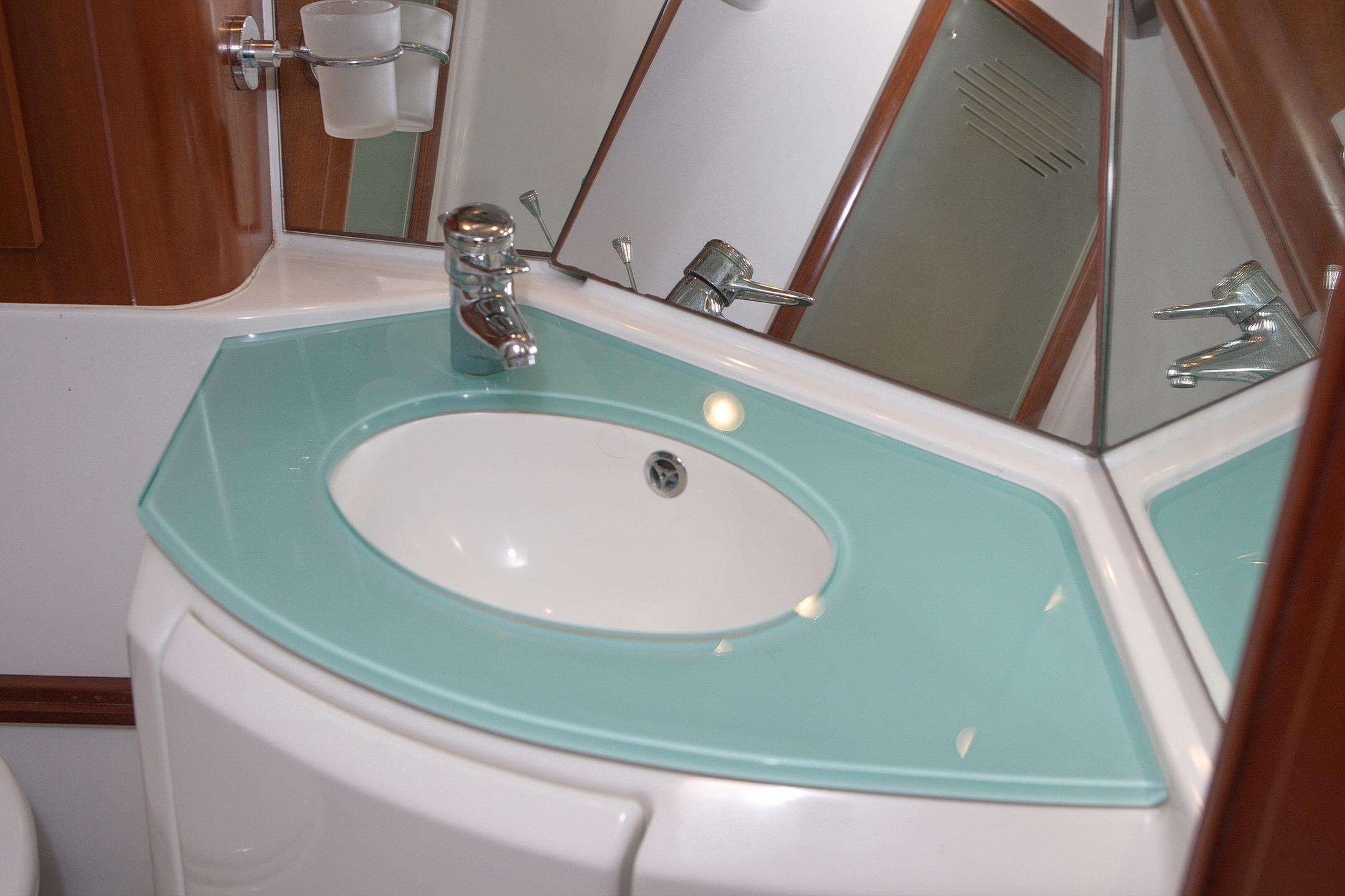 Bathroom sink with modern faucet in 2004 Beneteau Swift Trawler 42 yacht.
