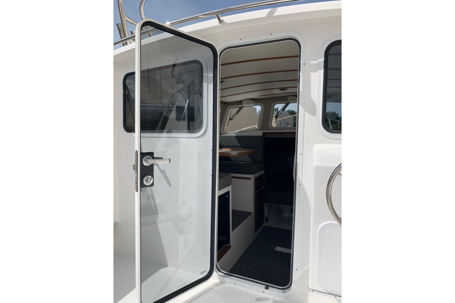 2026 Sea Sport Kenai 2600 boat interior view through open door.