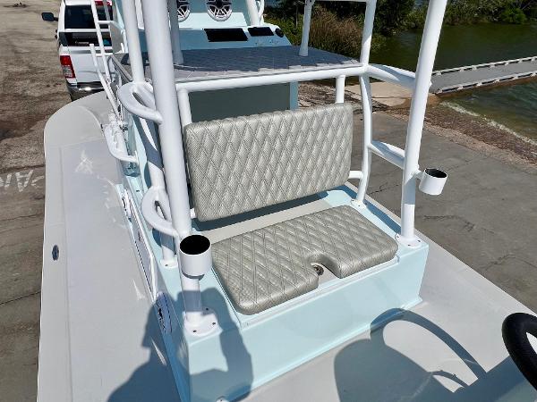 2022 Shallow Sport 20 Classic boat with cushioned seating and rod holders, docked near water.