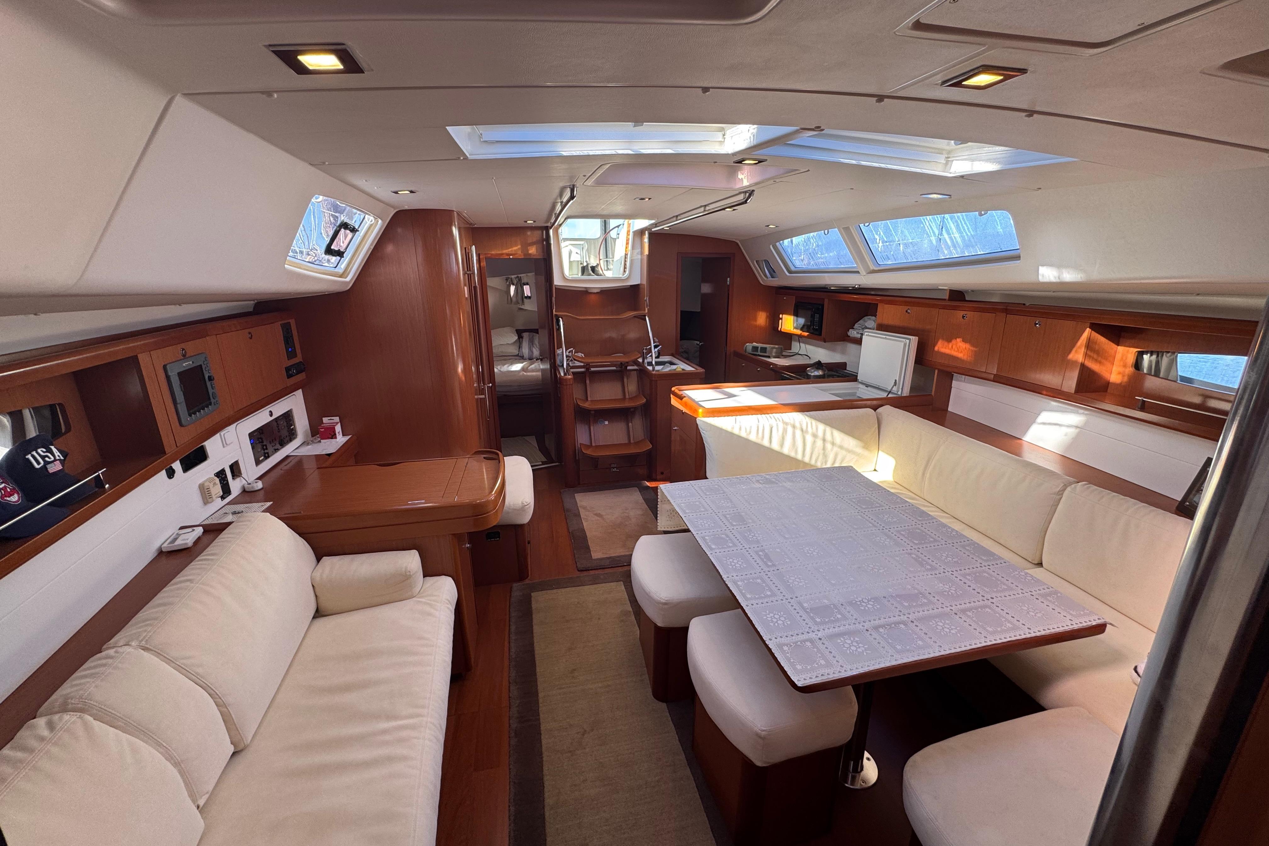 Luxurious interior of a 2009 Benetea 49 yacht with elegant seating and dining area.