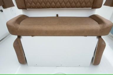 2026 Sea Hunt Ultra 255 SE boat seat with brown upholstery and white base.