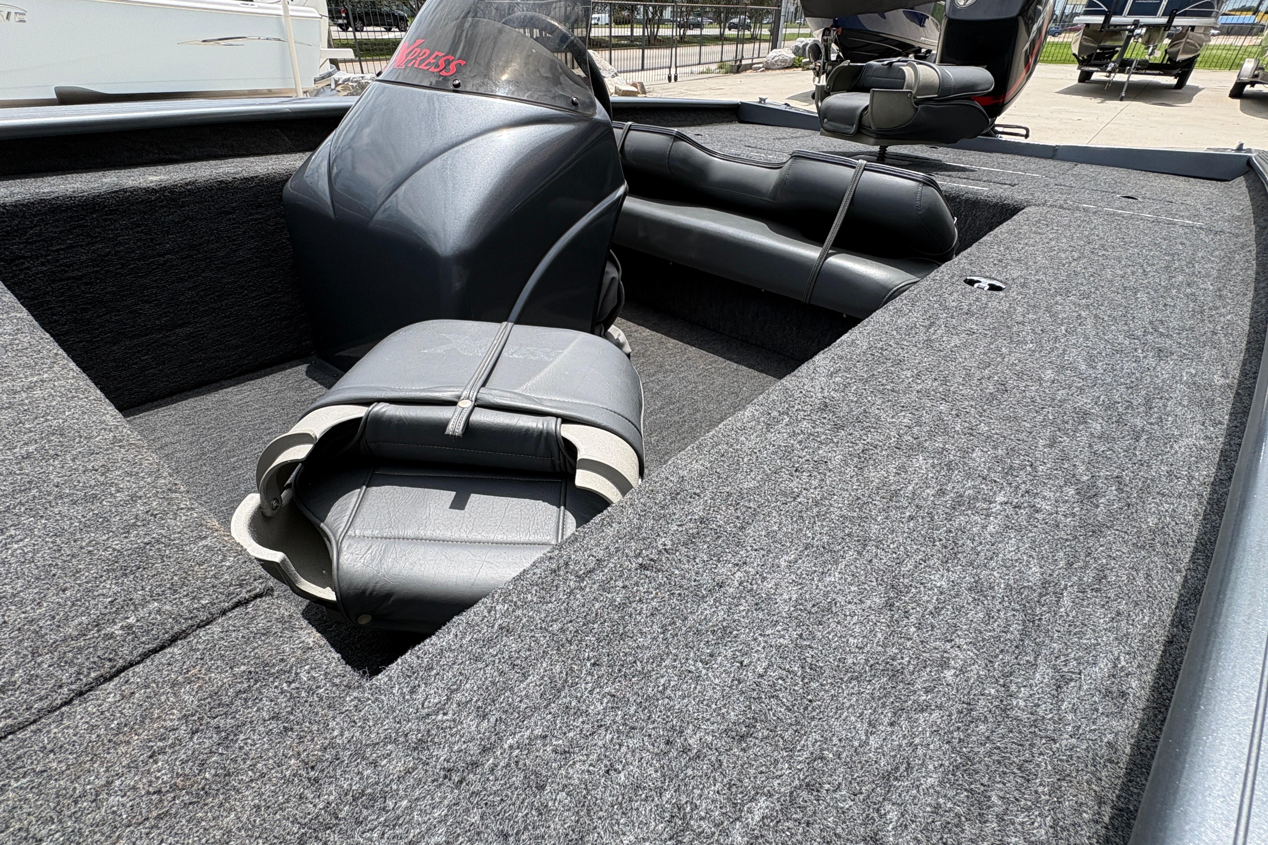 Interior of a 2000 Xpress X18 boat with seating and carpeted flooring.