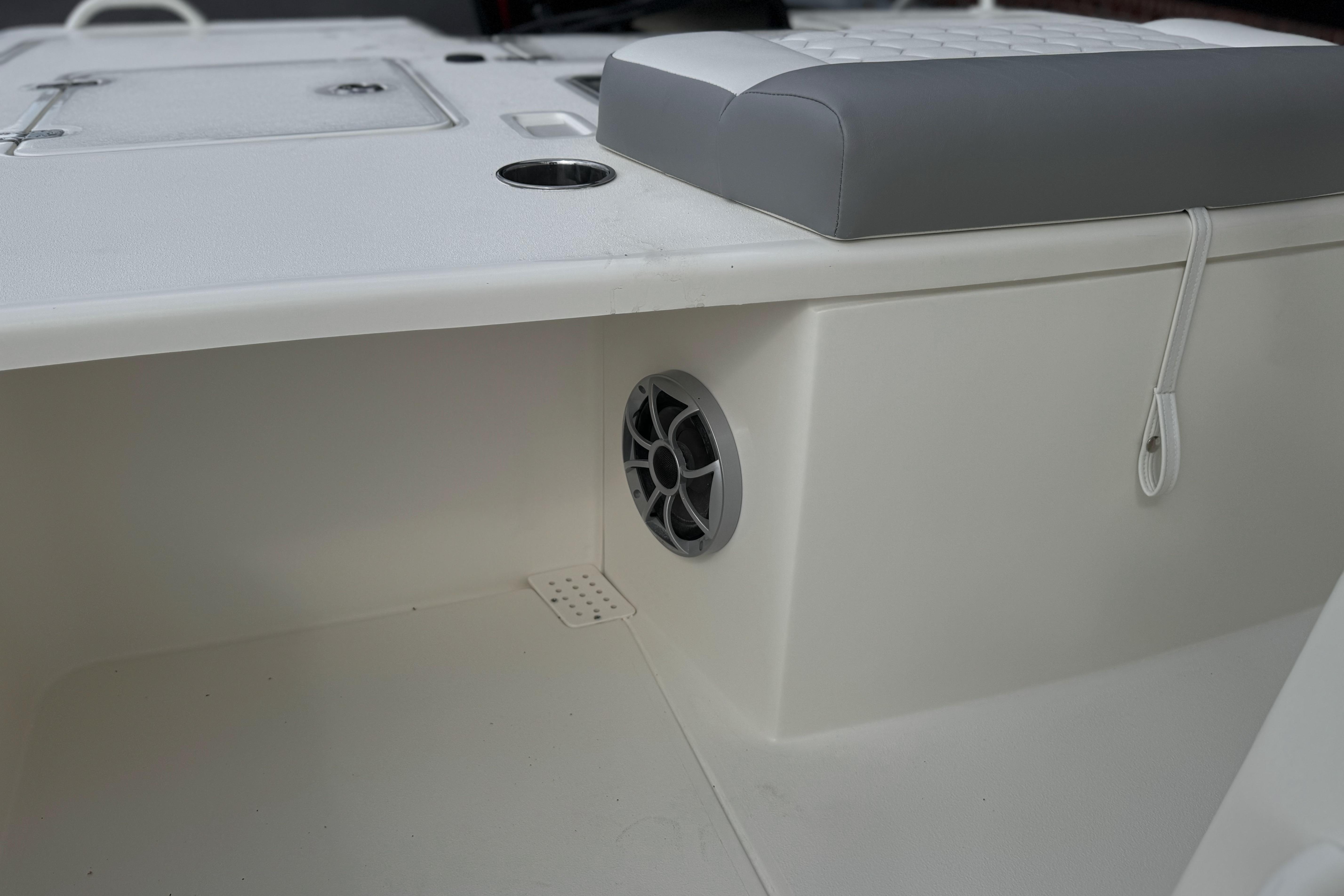 2026 Mako 18 Pro Skiff interior detail with speaker and cushioned seat.