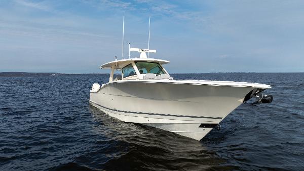 2025 Scout 425 LXF boat cruising on open water under a clear sky.