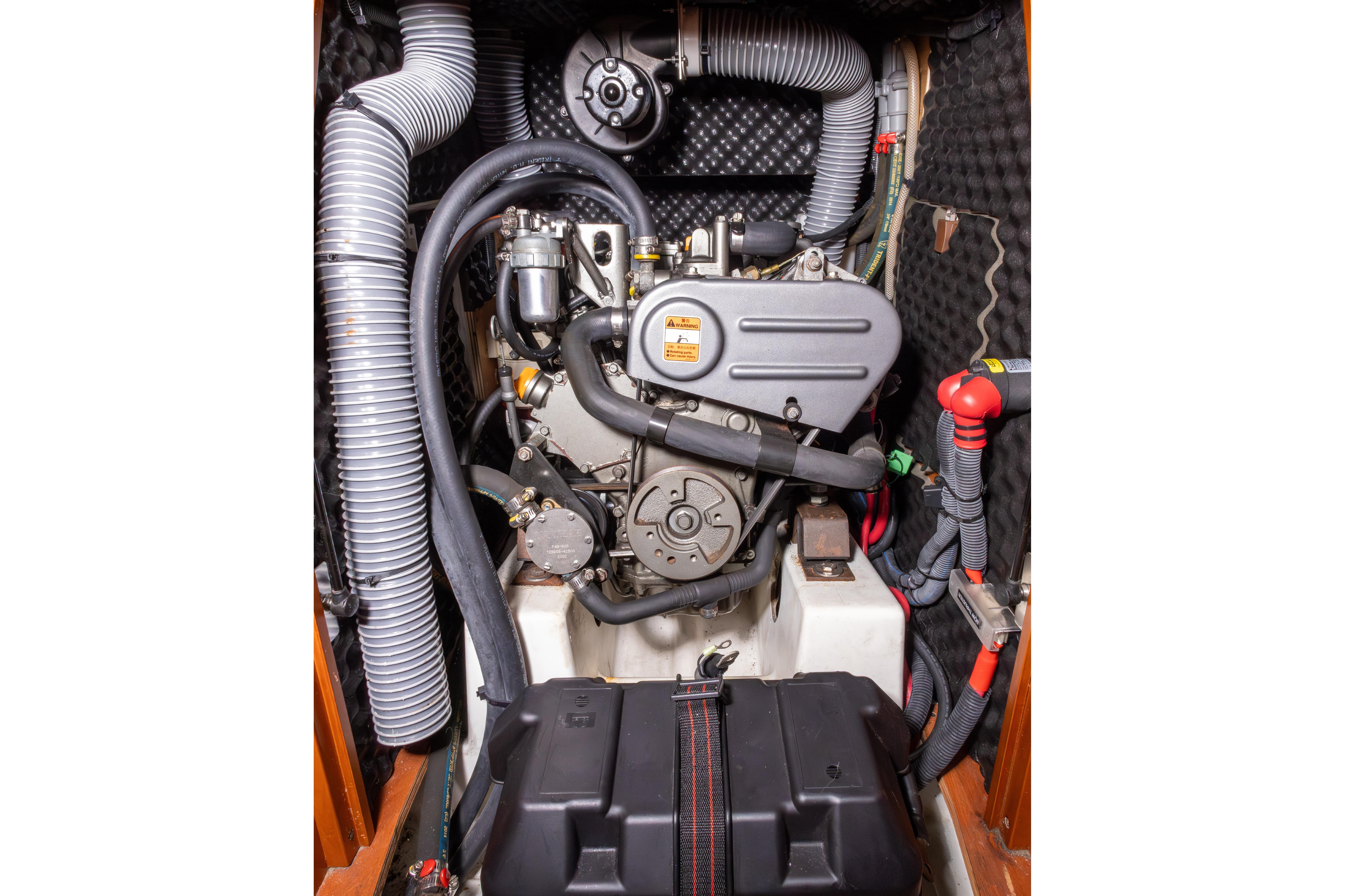 Engine compartment of a 2015 Beneteau Oceanis 37 sailboat, showcasing detailed mechanical components.