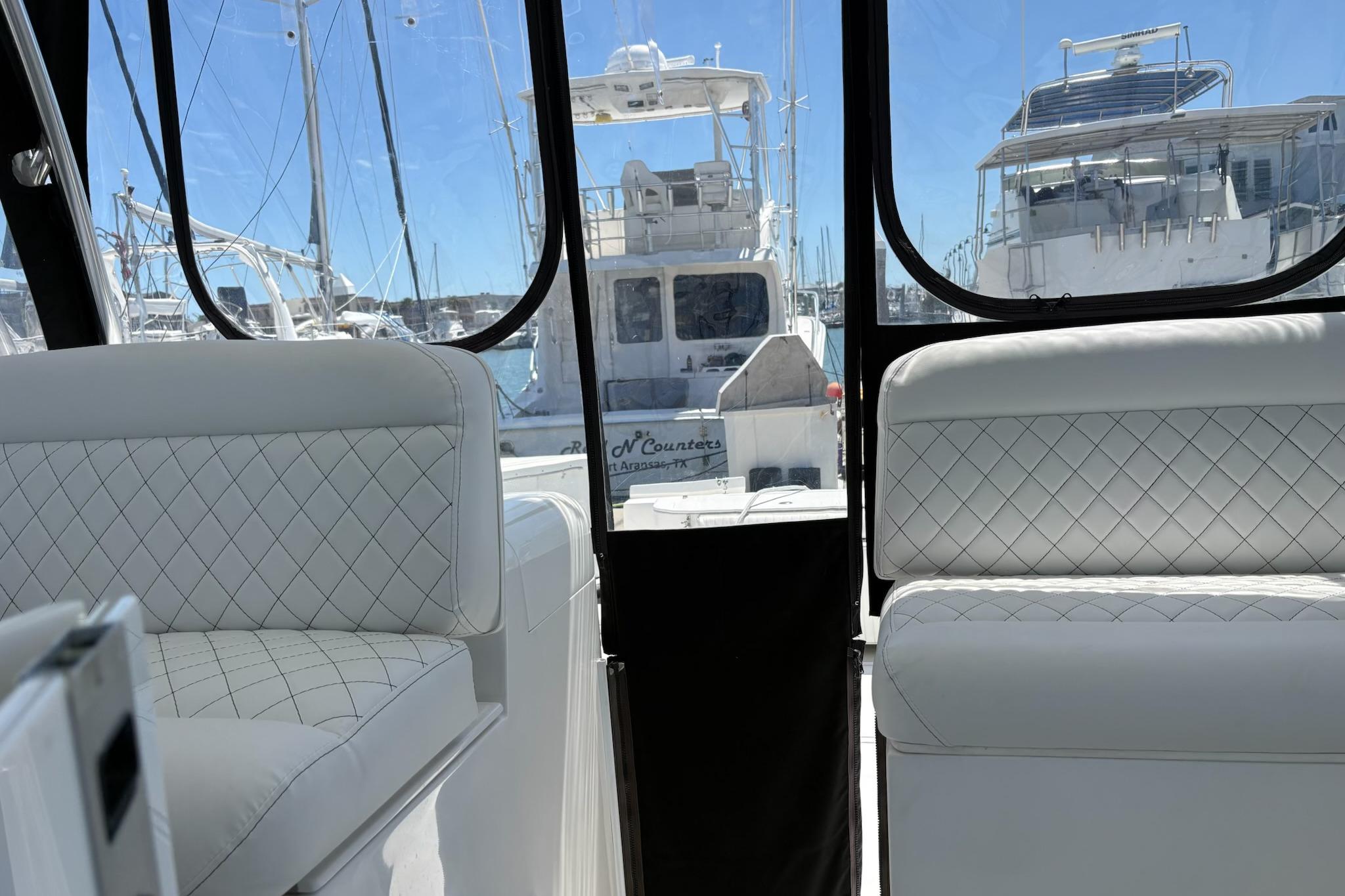 2008 Stamas 370 Express boat interior with white quilted seating, docked at marina.
