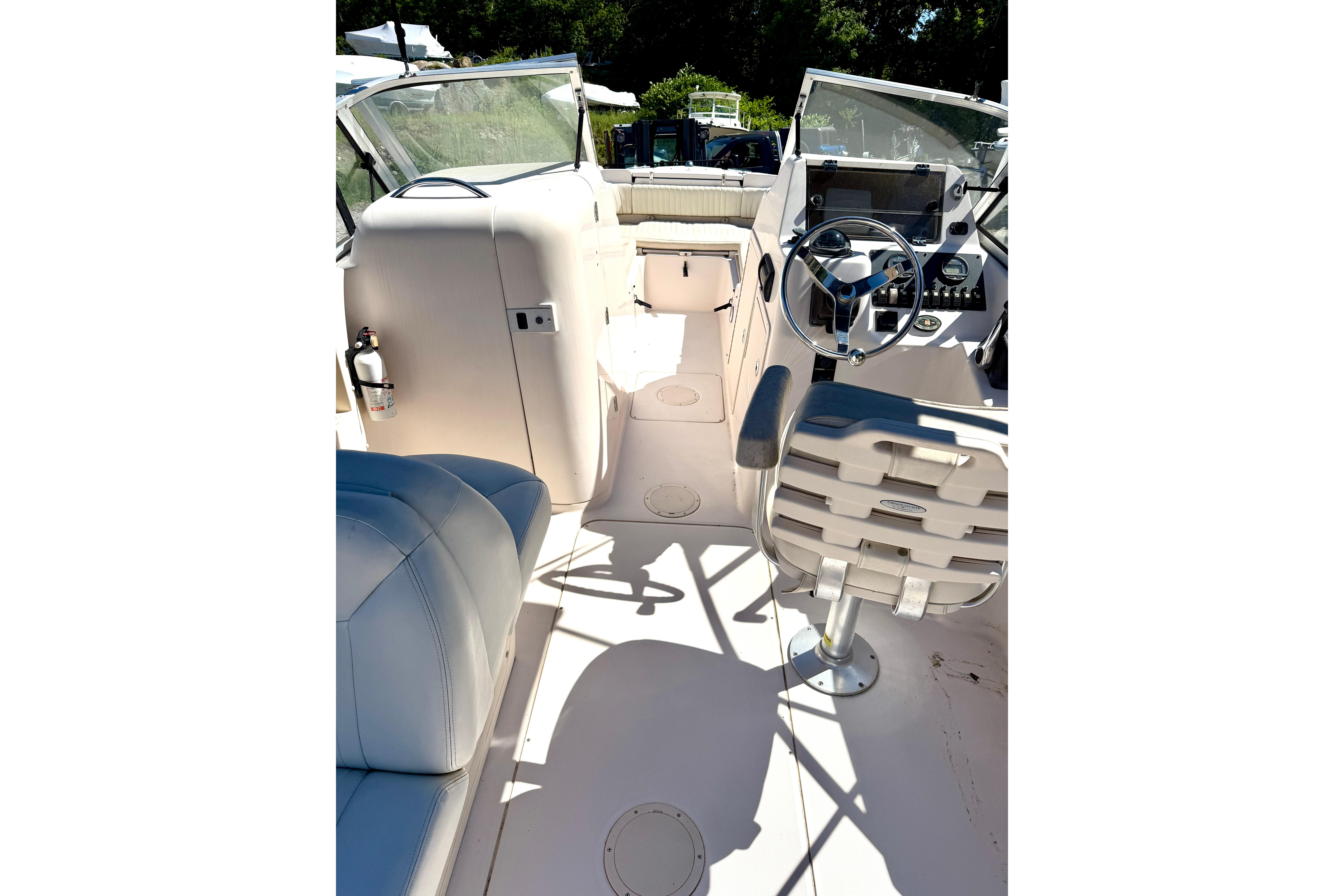 Interior view of a 2005 Grady-White Freedom 225 boat, featuring helm and seating area.