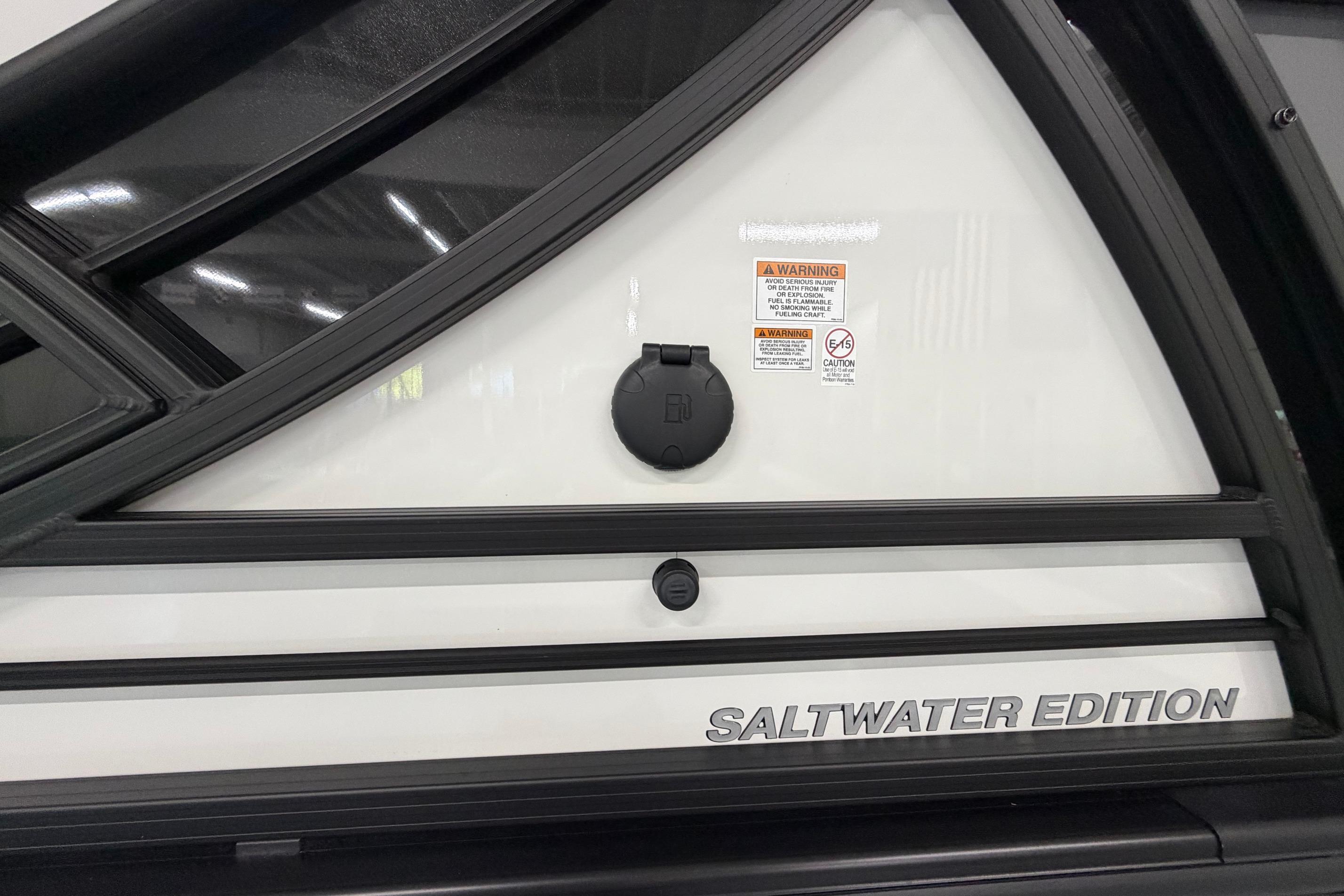 2026 South Bay 525SB2 Saltwater Edition boat detail with warning labels and sleek design.