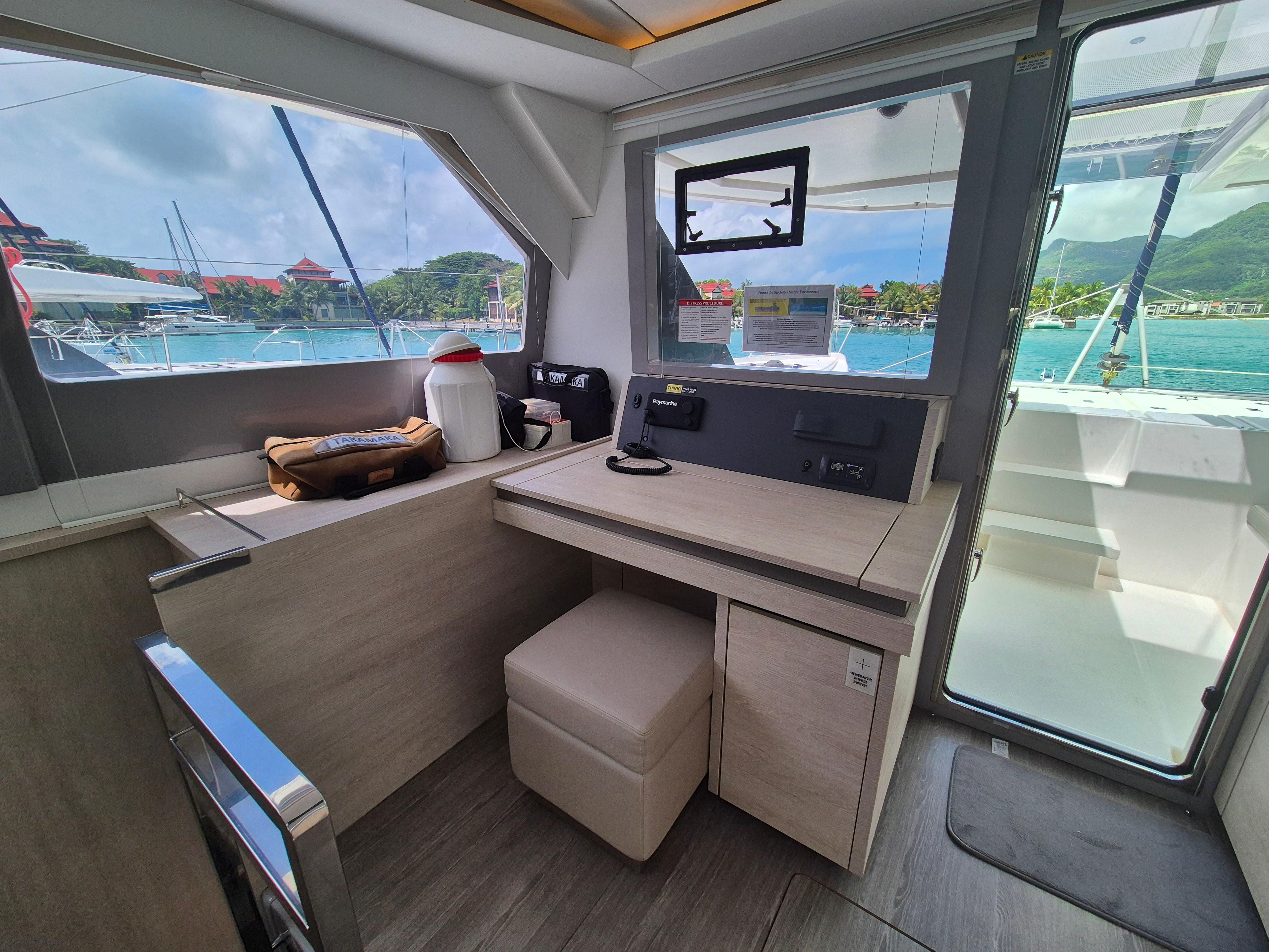 Interior of 2020 Leopard 50 yacht with navigation station and scenic marina view.